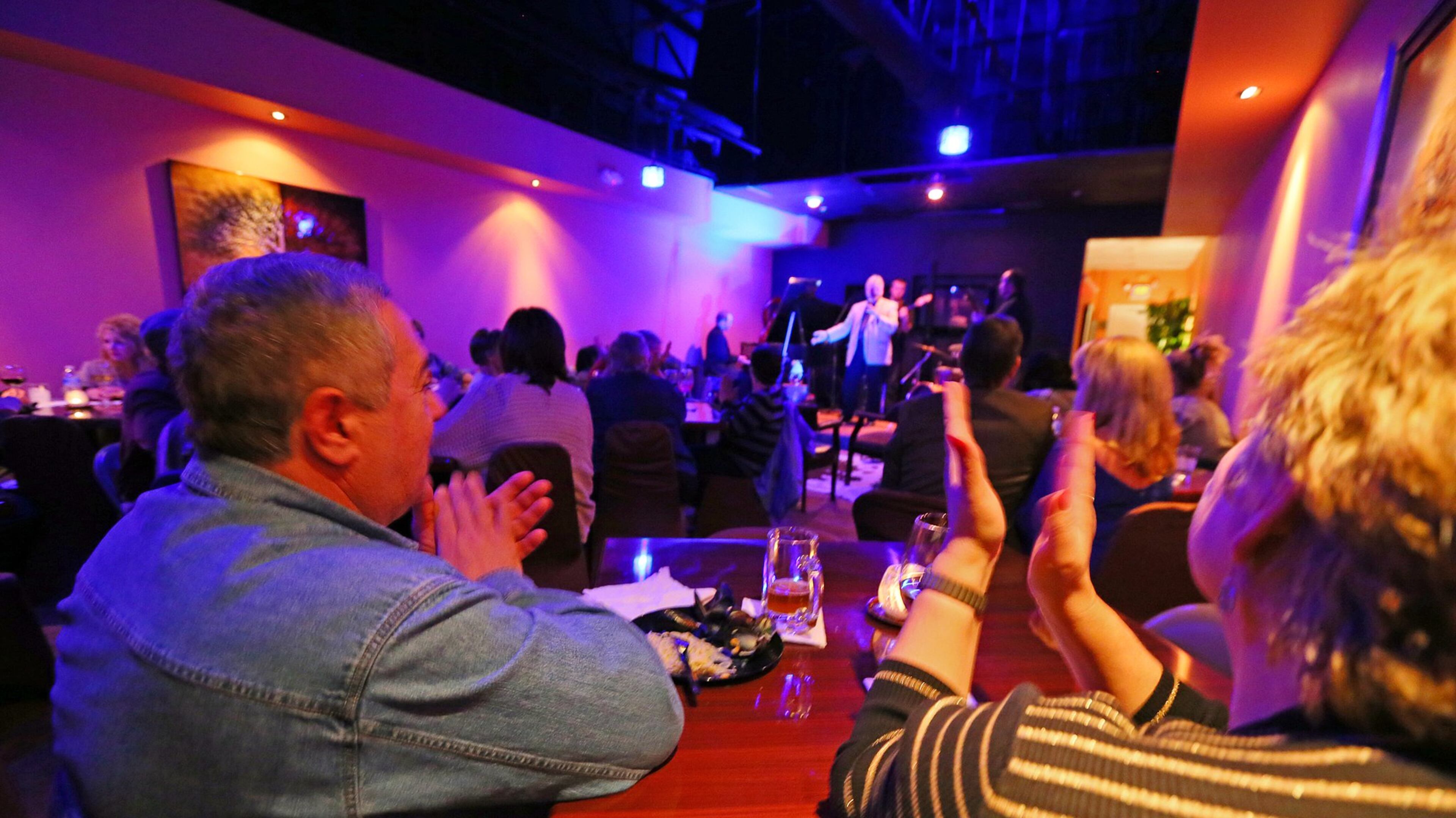 Patrons Greg and Marina Danskiy applaude for Ed Harris on vocals with the band Red Shift during jam night at the Velvet Note jazz club on Thursday, Jan. 31, 2013, in Alpharetta. CURTIS COMPTON / CCOMPTON@AJC.COM