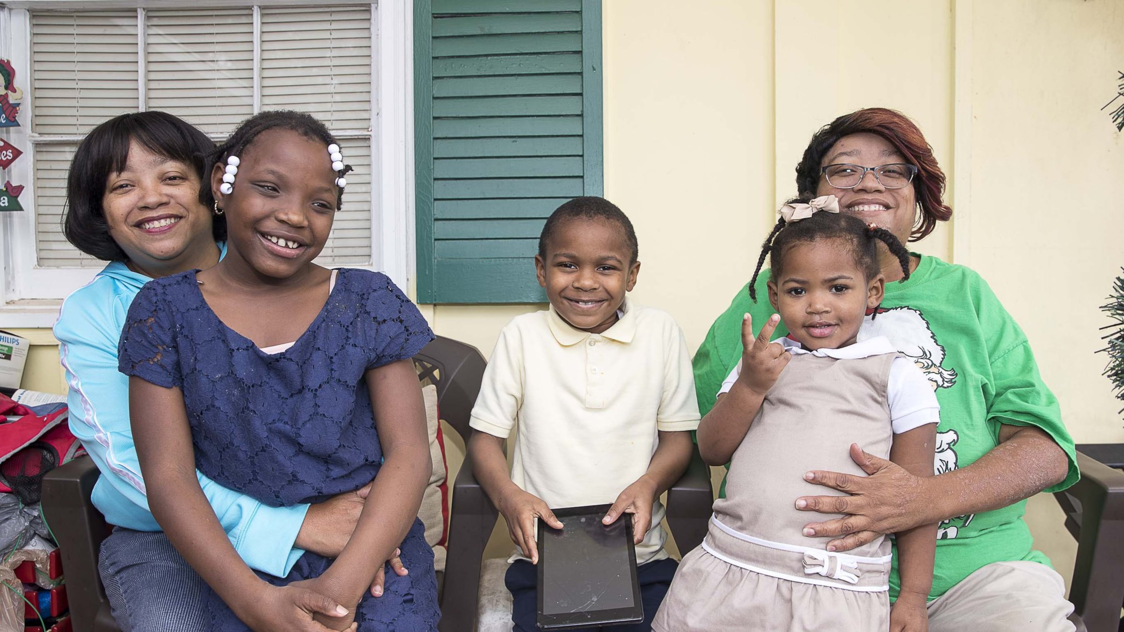 Twin sisters Priscilla (left) and Patricia (right) Moses have fostered more than 20 children, but now life revolves around their three adopted children: Ariah (from left), 9, Kristopher, 8, and Karrigan, 2.