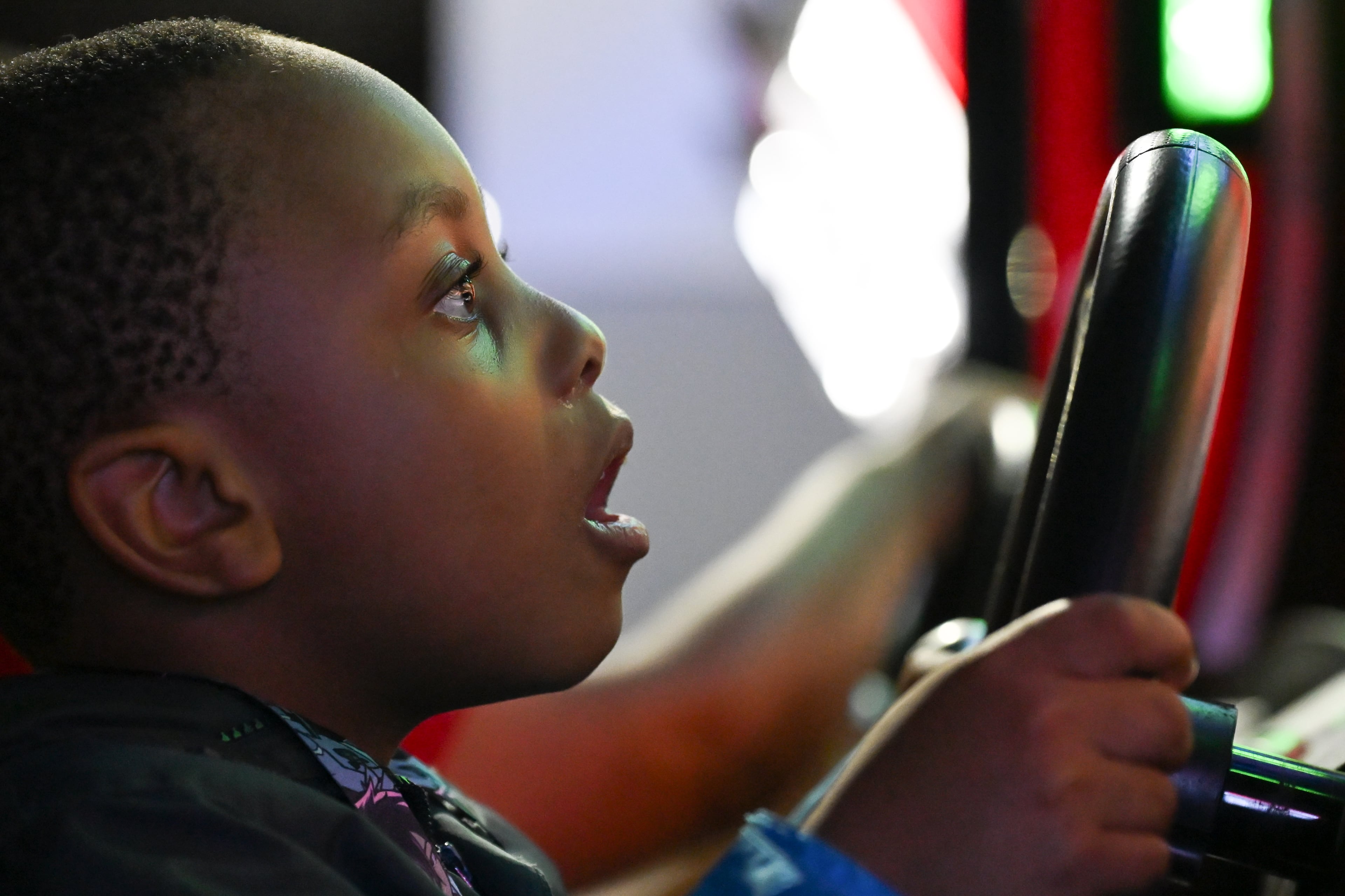 Jay Beasley plays an arcade racing game during MomoCon at the Georgia World Congress Center in Atlanta on Friday, May 22, 2026. MomoCon offers attendees access to a range of video and board games. (Tyler Sun for the AJC)