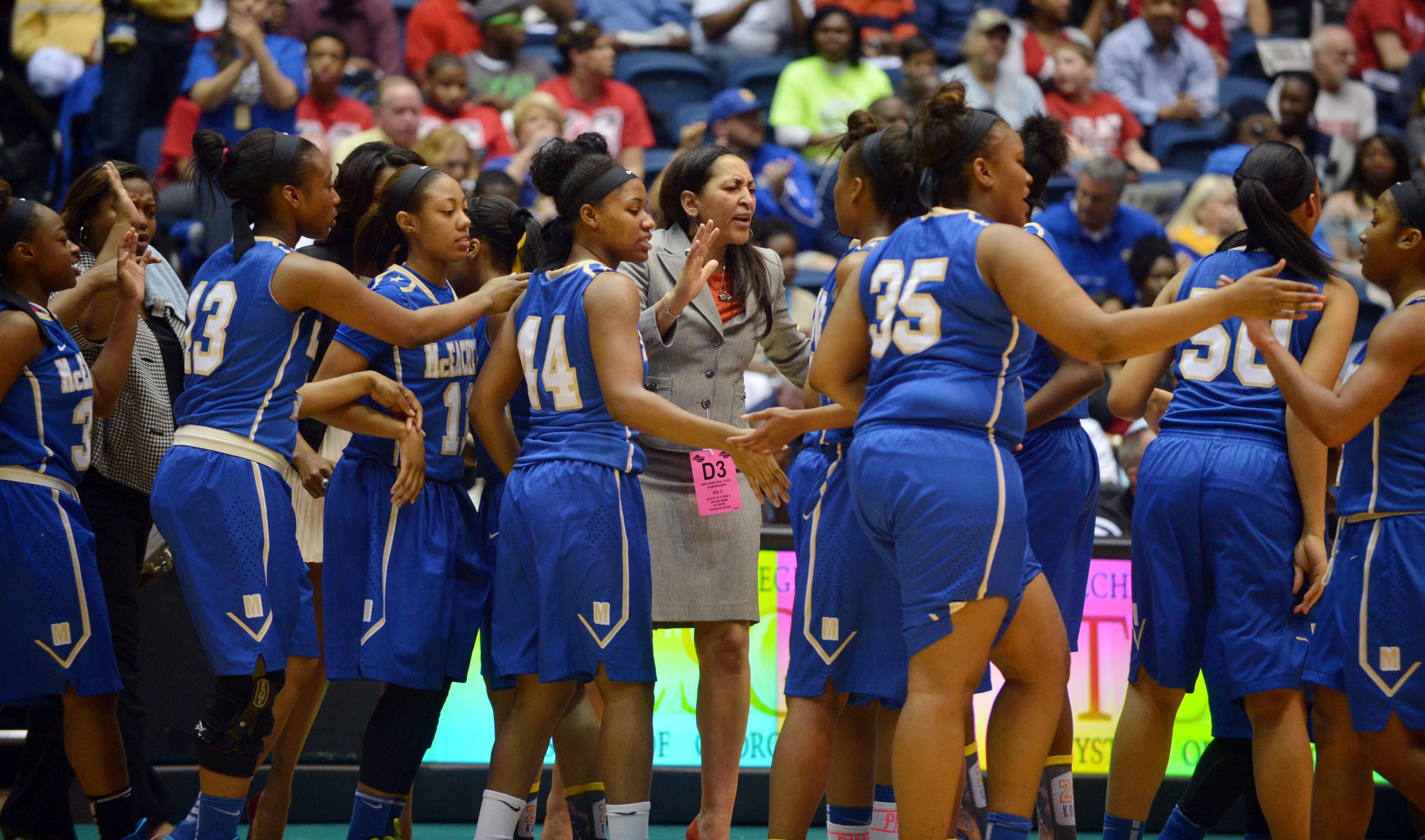 McEachern Indians head coach Phyllis Arthur talks with her players during action in the first half. Coverage of the Class AAAAAA girls basketball championship between the McEachern Indians and Archer Tigers at the Macon Coliseum Saturday, March 8, 2014. McEachearn led 39-35 at the half.