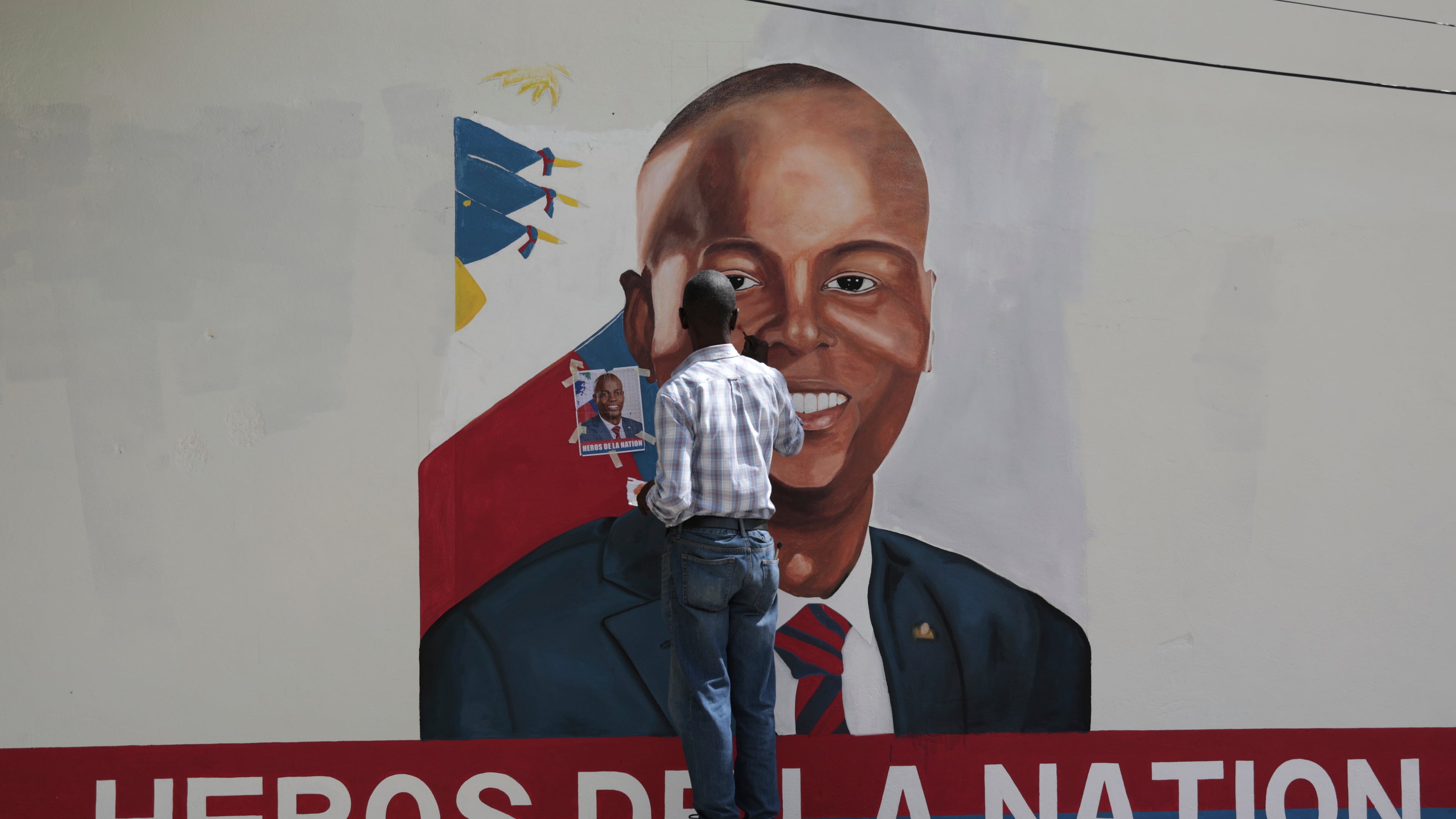 FILE - Artists paint a portrait of slain Haitian President Jovenel Moise near the presidencial residence where he was assassinated two years ago in the Petion-ville area of Port-au-Prince, Haiti, July 7, 2023. (AP Photo/Odelyn Joseph, File)