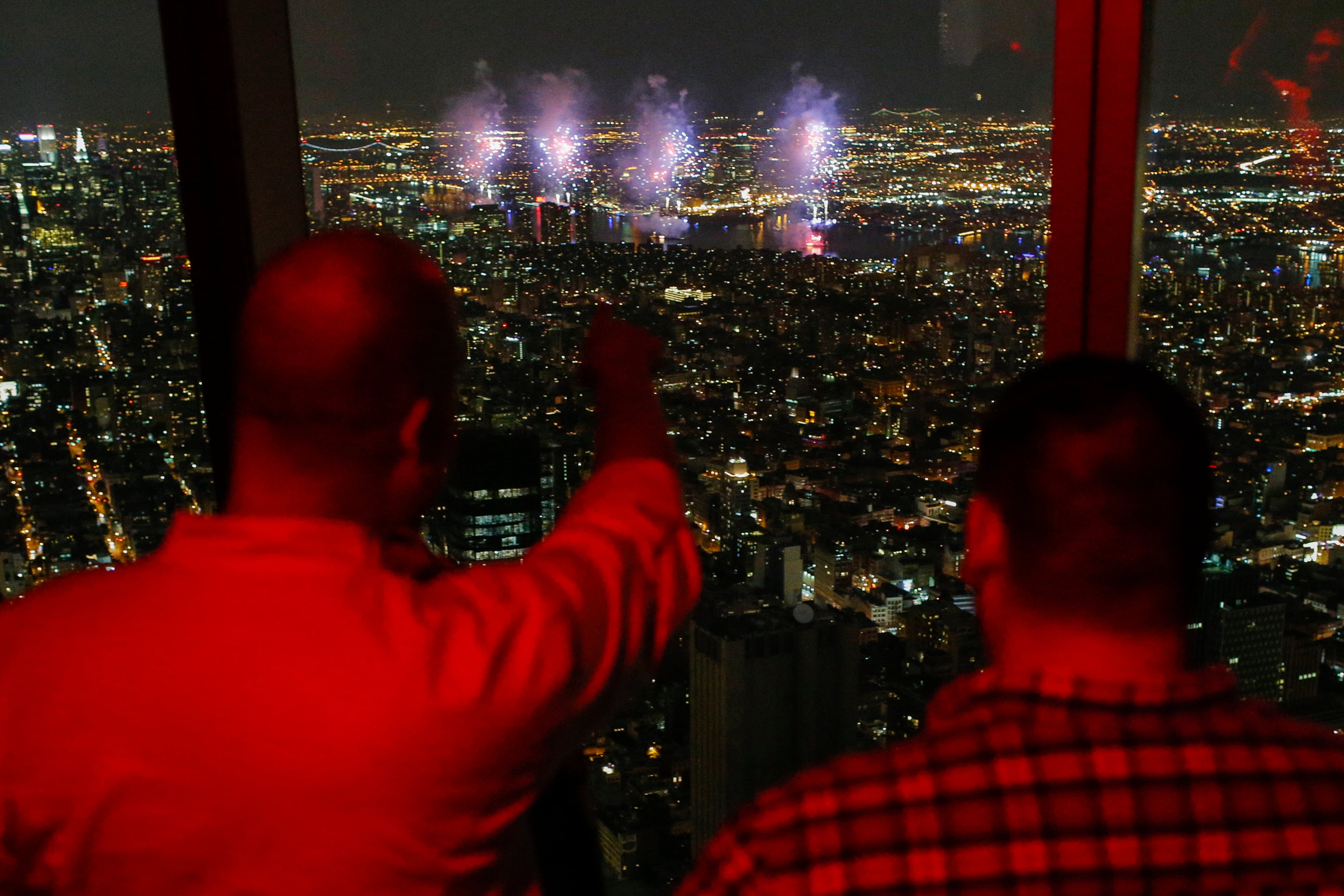 NEW YORK, NY - JULY 4: People look at The 2015 Macy's 4th of July Fireworks from the One World Trade Center Observatory on July 4, 2015 in New York City. The celebrations mark the 239th Independence Day. (Photo by Eduardo Munoz Alvarez/Getty Images)