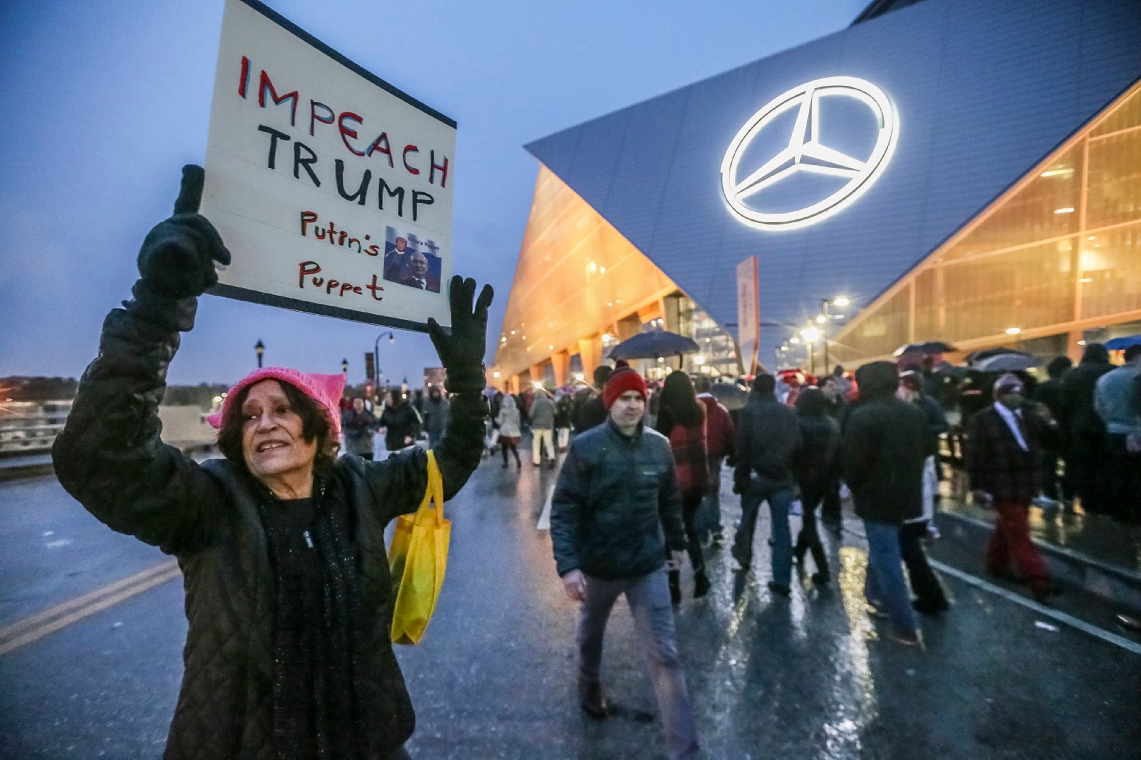 January 8, 2018 Atlanta: Patricia Churney came alone to protest Trump's visit to downtown Atlanta on Monday, Jan. 8, 2018 at the Mercedes-Benz Stadium. The Alabama Crimson Tide were 3.5-point favorites going into Monday nightâs College Football Playoff Championship against the Georgia Bulldogs at Atlantaâs Mercedes-Benz Stadium. Gov. Nathan Deal ordered non-essential state offices from Columbus to Augusta and northward to close Monday, and city of Atlanta officials announced a similar order for local offices. Officials began announcing closures to ease traffic burdens early, in large part because of the game. The 8pm kick off for the championship, will see US President Donald Trump in attendance. Kendrick Lamar was scheduled to perform a free halftime concert at Centennial Olympic Park. JOHN SPINK/JSPINK@AJC.COM