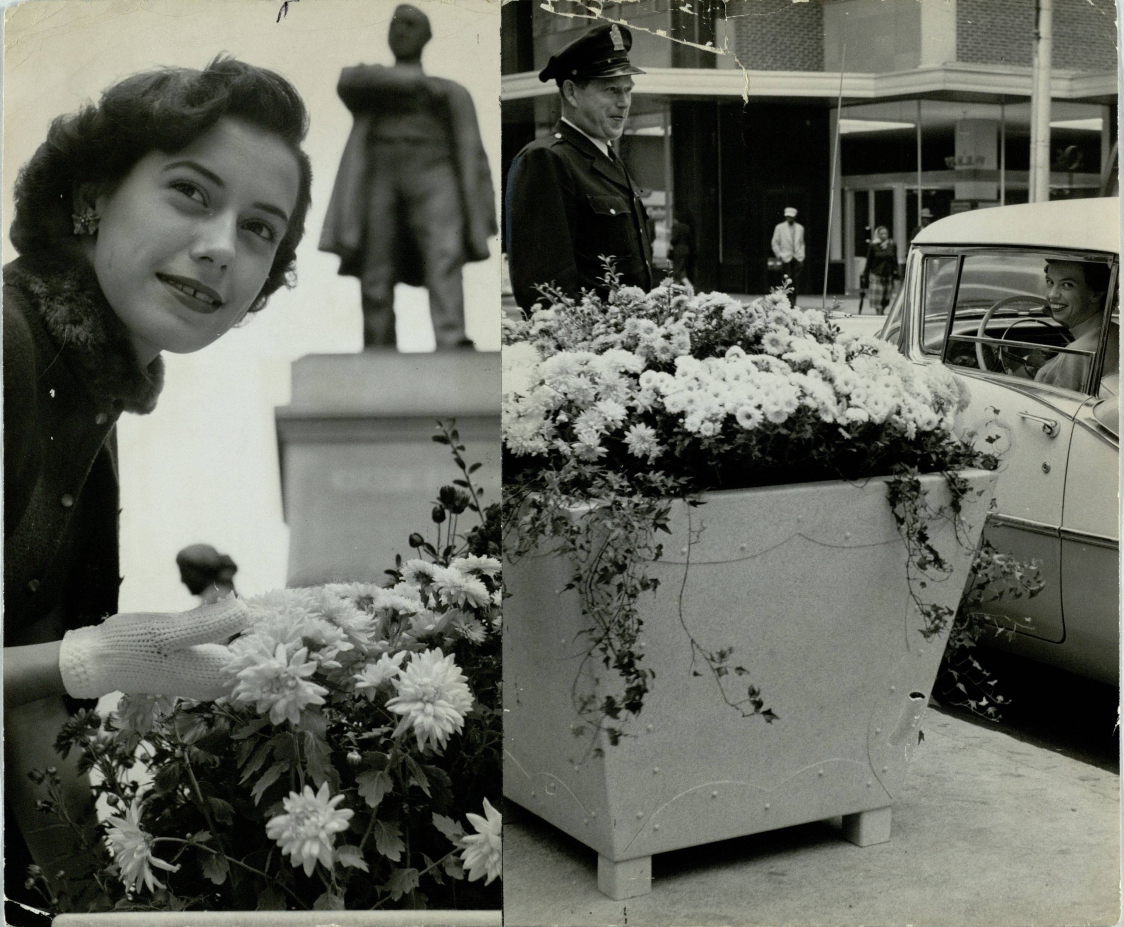 On Marietta Street in October 1956. The description on the back of the original: "A BLOOMING SURPRISE Earlybird workers were the first to notice, but by afternoon thousands has seen the big urns of flowers put out the night before on Marietta street between Forsyth street and Five Points. Six will be maintained on the Marietta traffic islands with the flowers being changed seasonably. Mayor Hartsfield provided them out of his expense funds. At left Mildred Katz sniffs the blooms --- azalea mums--- beneath the Henry Grady monument. At right, officer Burl Cobbins lets Mrs. Nona Gover stop her car long enough to look."