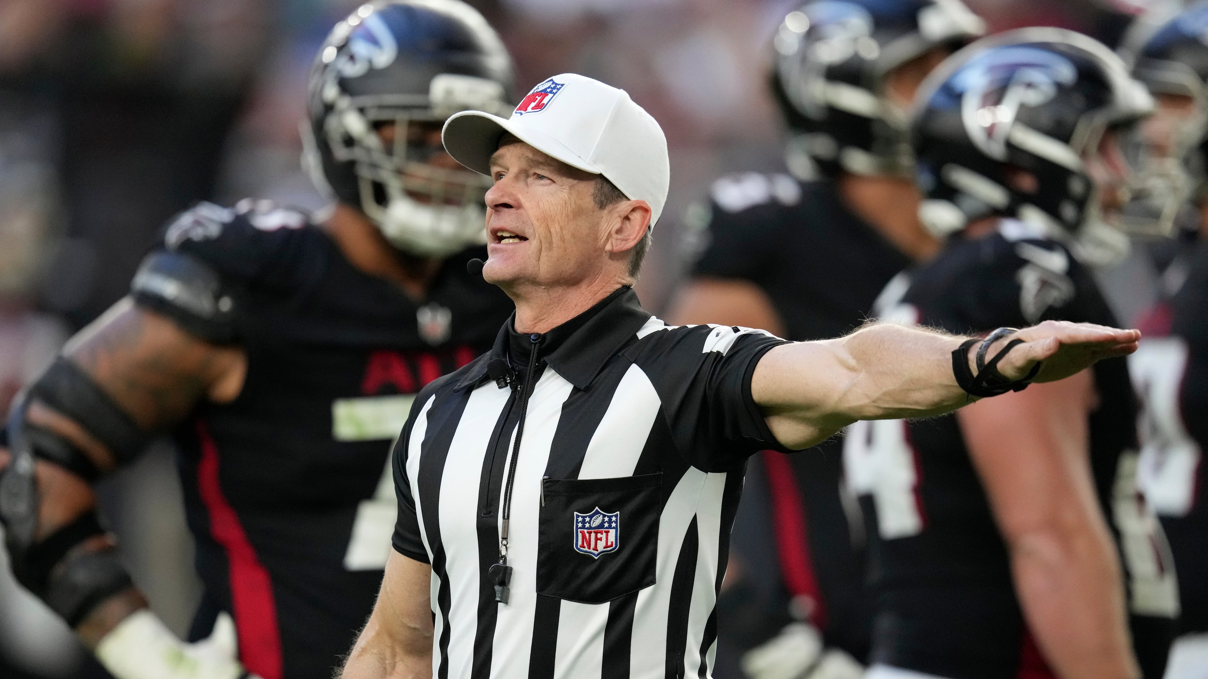 FILE - Referee Land Clark annouces a penalty during the second half of an NFL football game between the Arizona Cardinals and the Atlanta Falcons Sunday, Dec. 21, 2025, in Glendale, Ariz. (AP Photo/Ross D. Franklin, File)