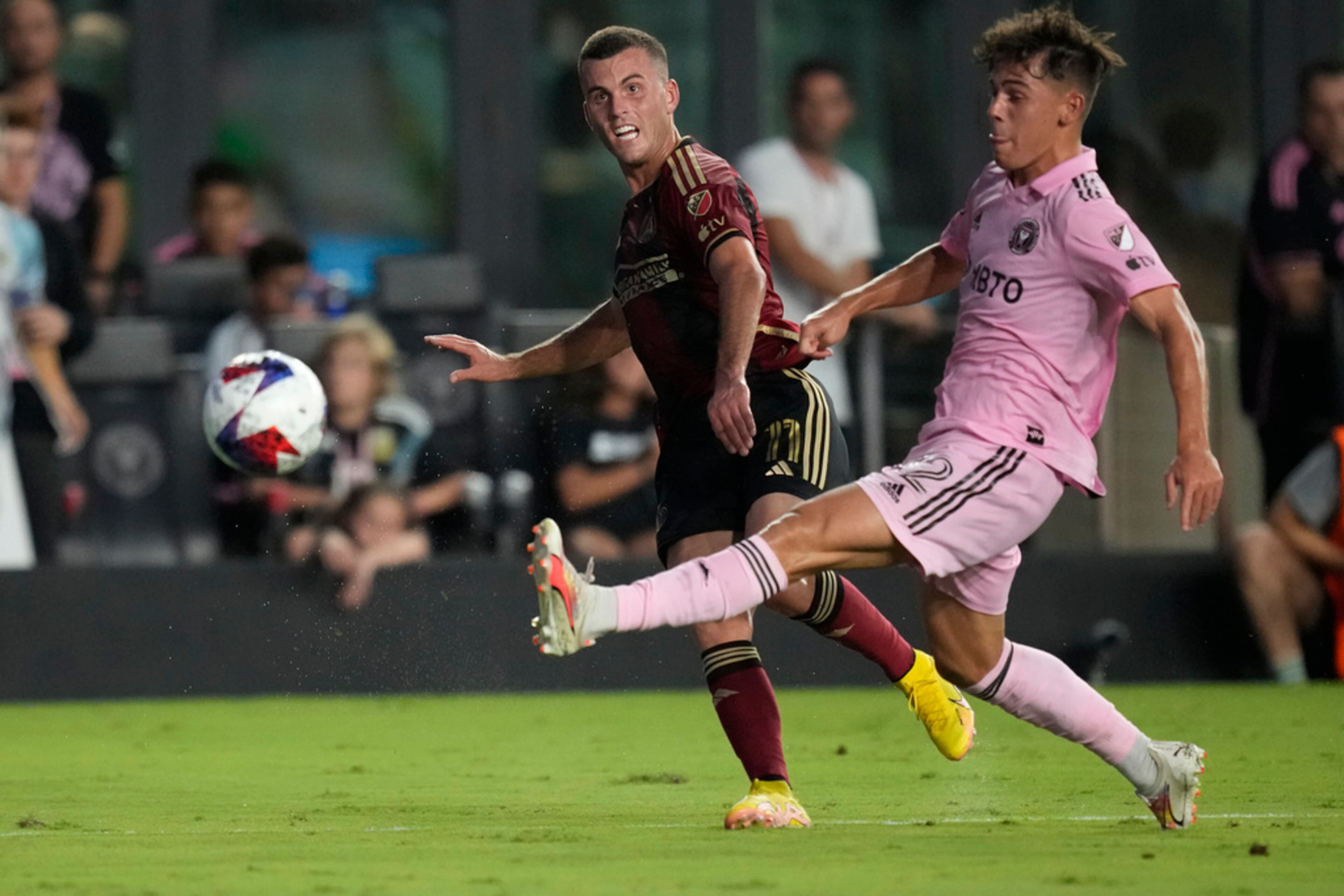 Inter Miami defender DeAndre Yedlin (2) kicks the ball away from Atlanta United defender Brooks Lennon (11) during the first half of a Leagues Cup soccer match, Tuesday, July 25, 2023, in Fort Lauderdale, Fla. (AP Photo/Rebecca Blackwell)