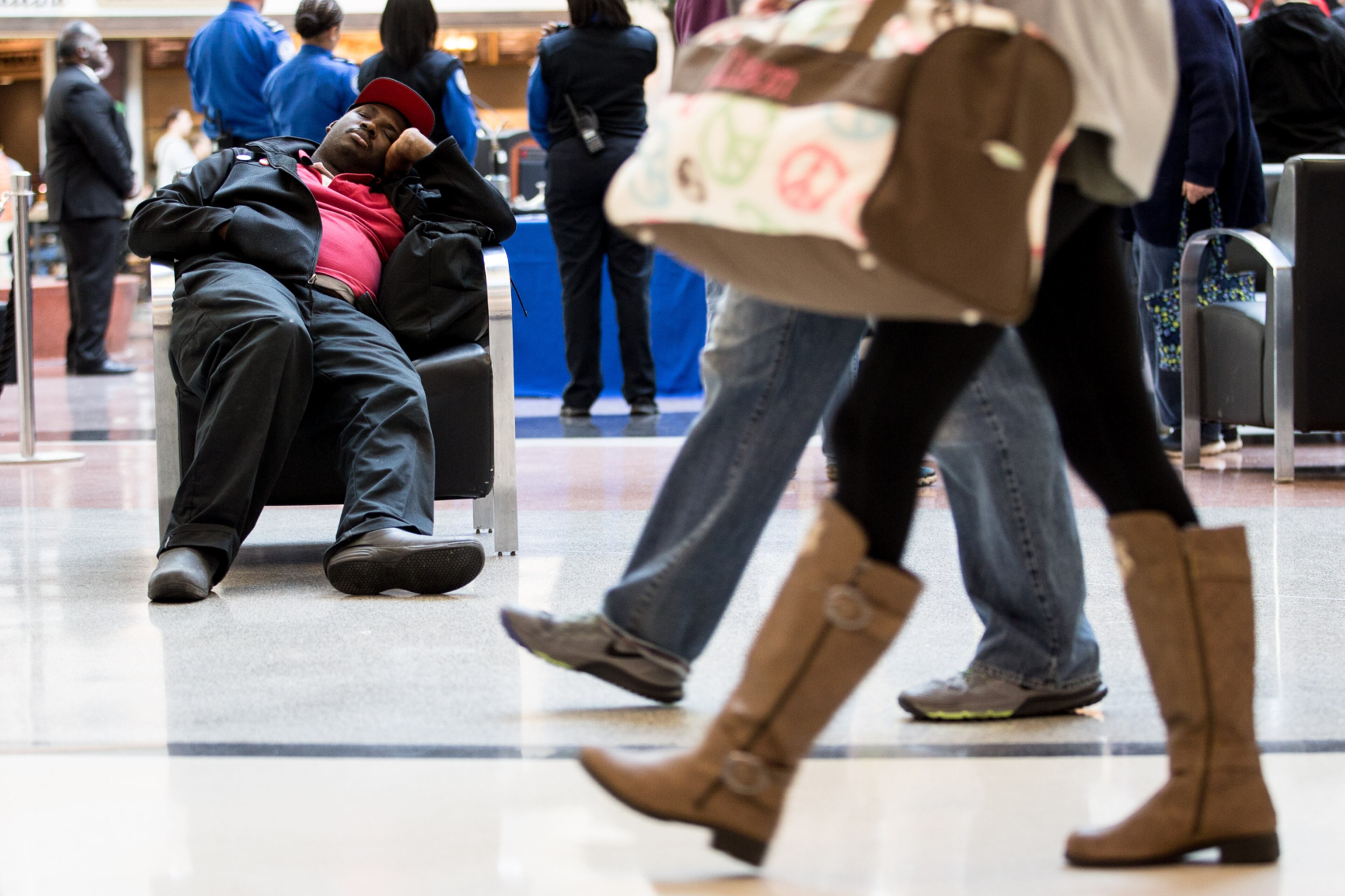 A traveler sleeps in the atrium at Hartsfield-Jackson Atlanta International Airport, Tuesday, Nov. 22, 2016, in Atlanta. Hartsfield-Jackson International Airport expects to handle more than 2.9 million passengers over the Thanksgiving travel period. BRANDEN CAMP/SPECIAL