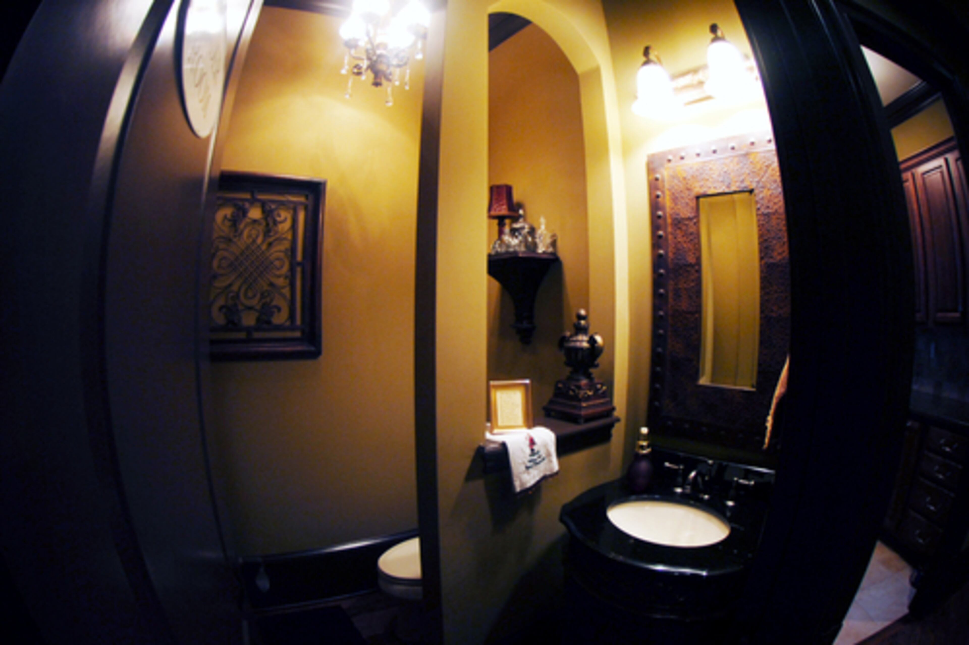 The downstairs powder room was built with a half wall to separate the toilet and sink.