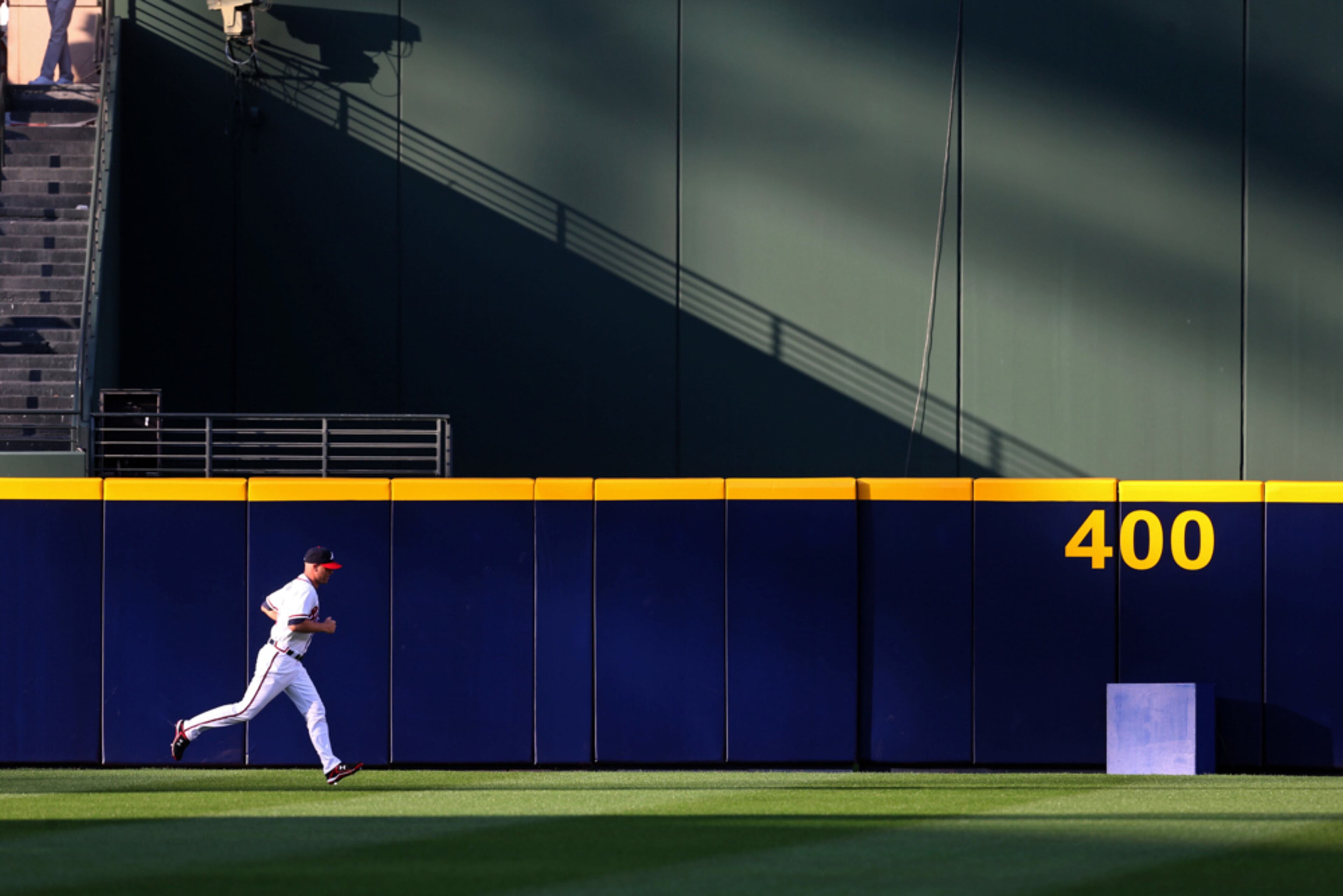 April 1, 2013 - Atlanta, Ga: Atlanta Braves pitcher Tim Hudson warms up in the outfield before he start in their season opener against the Philadelphia Phillies at Turner Field Friday afternoon in Atlanta, Ga., April 2, 2013. Getz said, "This is not your normal opening day type image. In fact this is the type of image that I know would not see the newspaper, but I love the light and quiet moment pitcher Hudson has before his first pitch." JASON GETZ / JGETZ@AJC.COM