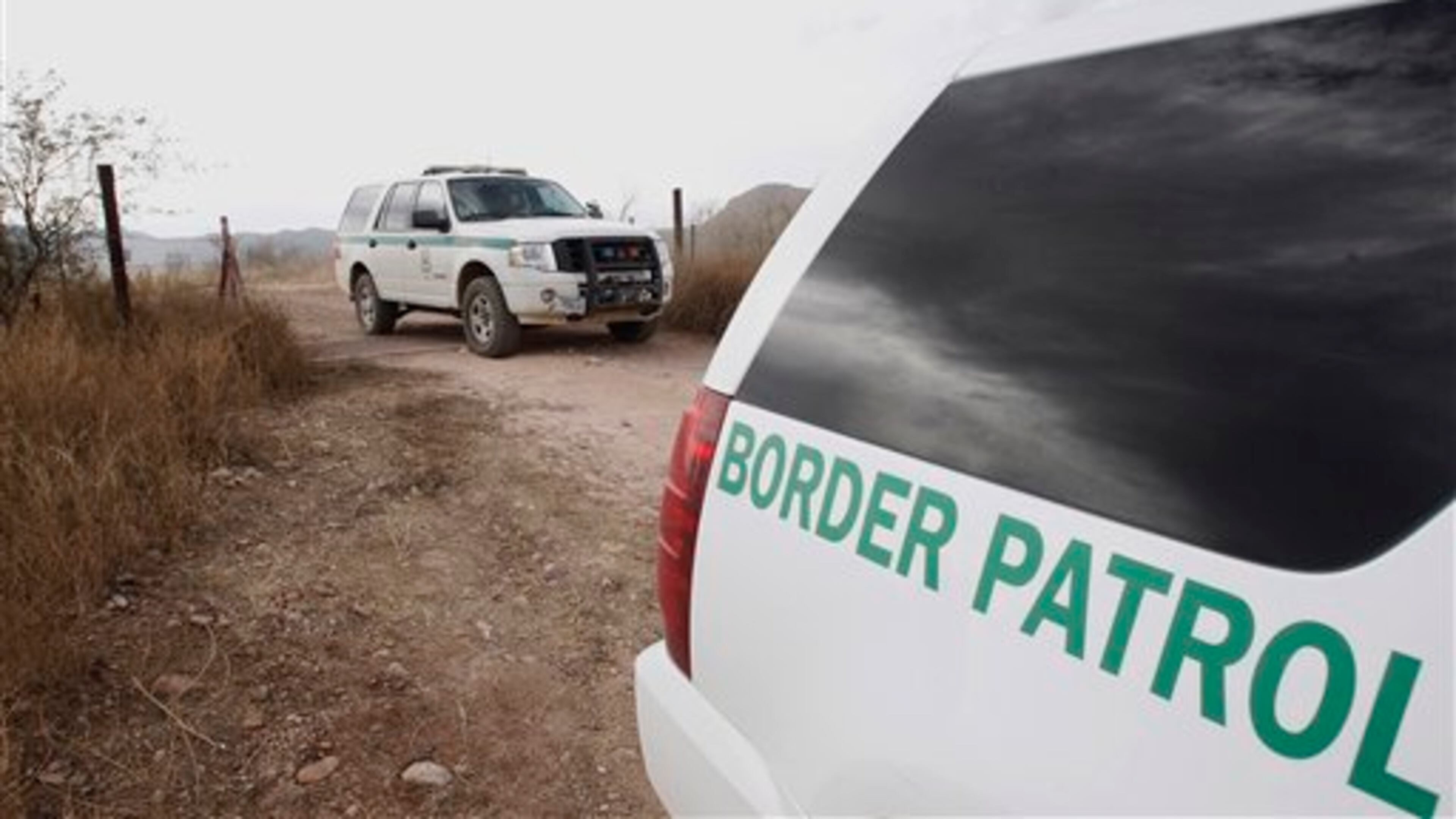 FILE - In this Thursday, Dec. 16, 2010 file photo, U.S. Border Patrol vehicles come and go from a checkpoint, as teams of border officers comb through the Arizona desert about 10 miles north of Mexico in search of the lone outstanding suspect in the fatal shooting of Border Patrol agent Brian Terry in the rugged terrain in Rio Rico, Ariz. The shooting Tuesday night came after agents spotted suspected bandits known for targeting illegal immigrants along a violent smuggling corridor. State Sen. Steve Smith, R-Maricopa, was the sponsor of a bill that was signed into law recently that will use donated money and inmate labor to build a "secure fence" along the U.S.-Mexico border. (AP Photo/Ross D. Franklin, file)