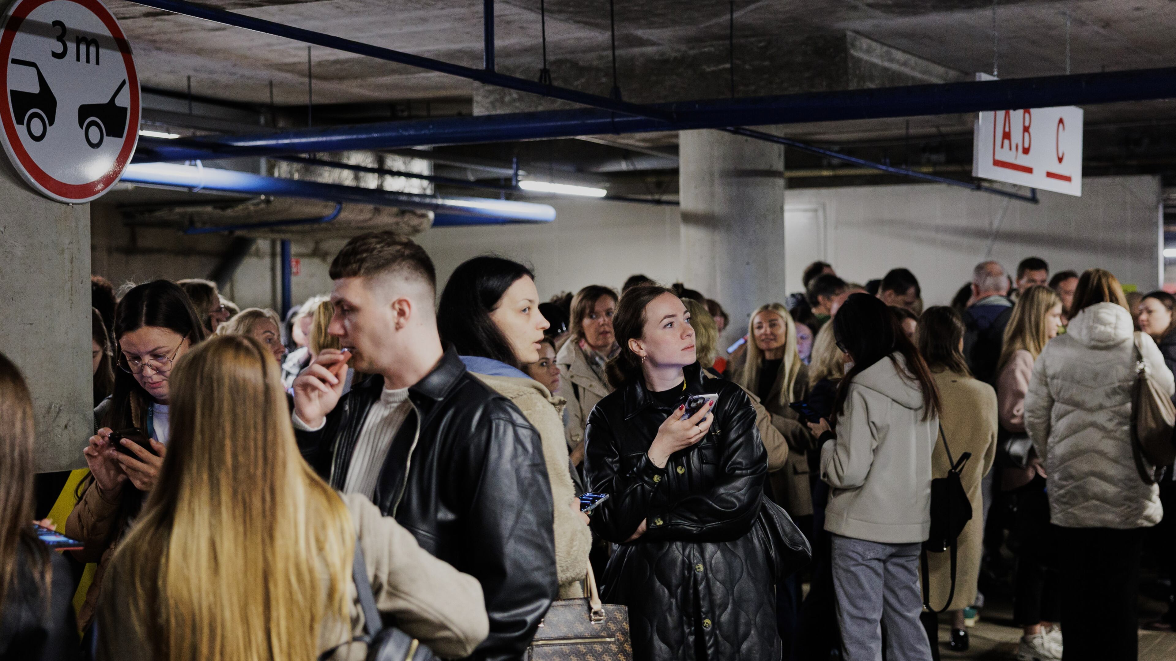People take shelter in an underground car park during an air raid alert in Vilnius, Lithuania, Wednesday, May 20, 2026. (Vygintas Skaraitis/Lrytas via AP)