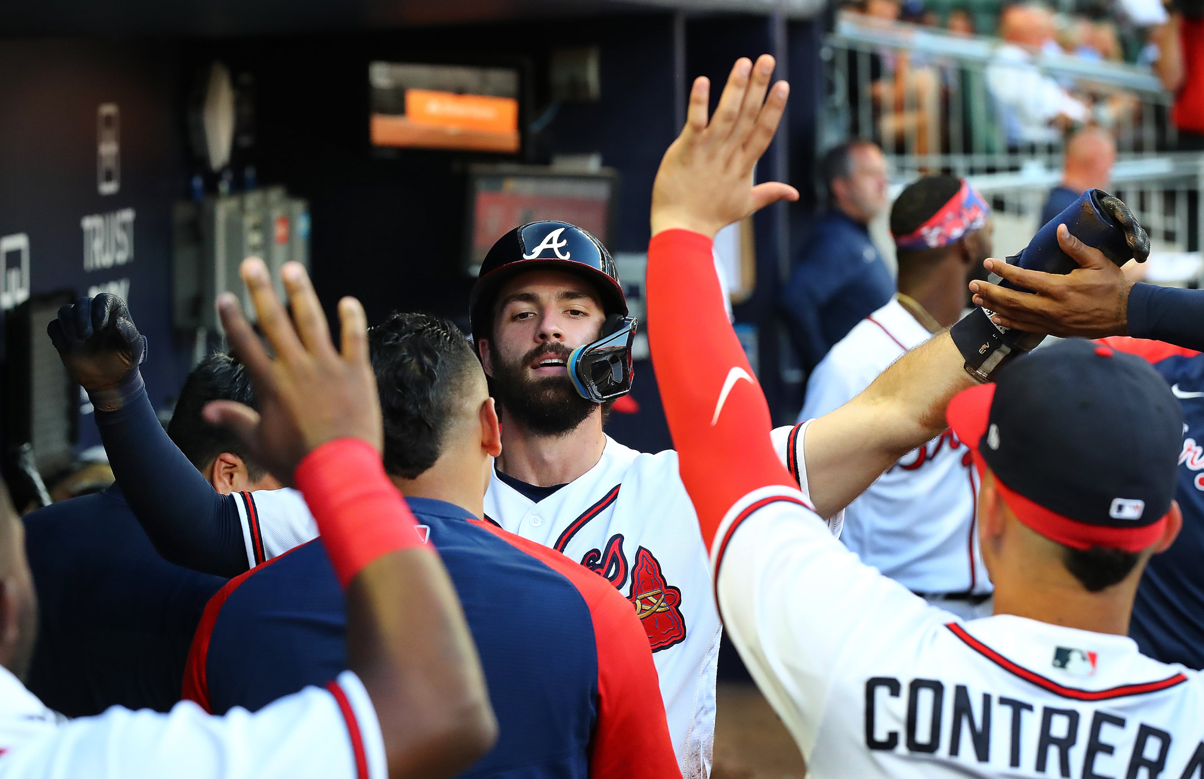 Atlanta Braves shortstop Dansby Swanson gets high fives in the dugout scoring on a RBI double by Travis d'Arnaud to take a 3-0 lead over the Pittsburgh Pirates during the third inning in a MLB baseball game on Thursday, June 9, 2022, in Atlanta. The Braves beat the Pirates 3-1. Curtis Compton / Curtis.Compton@ajc.com