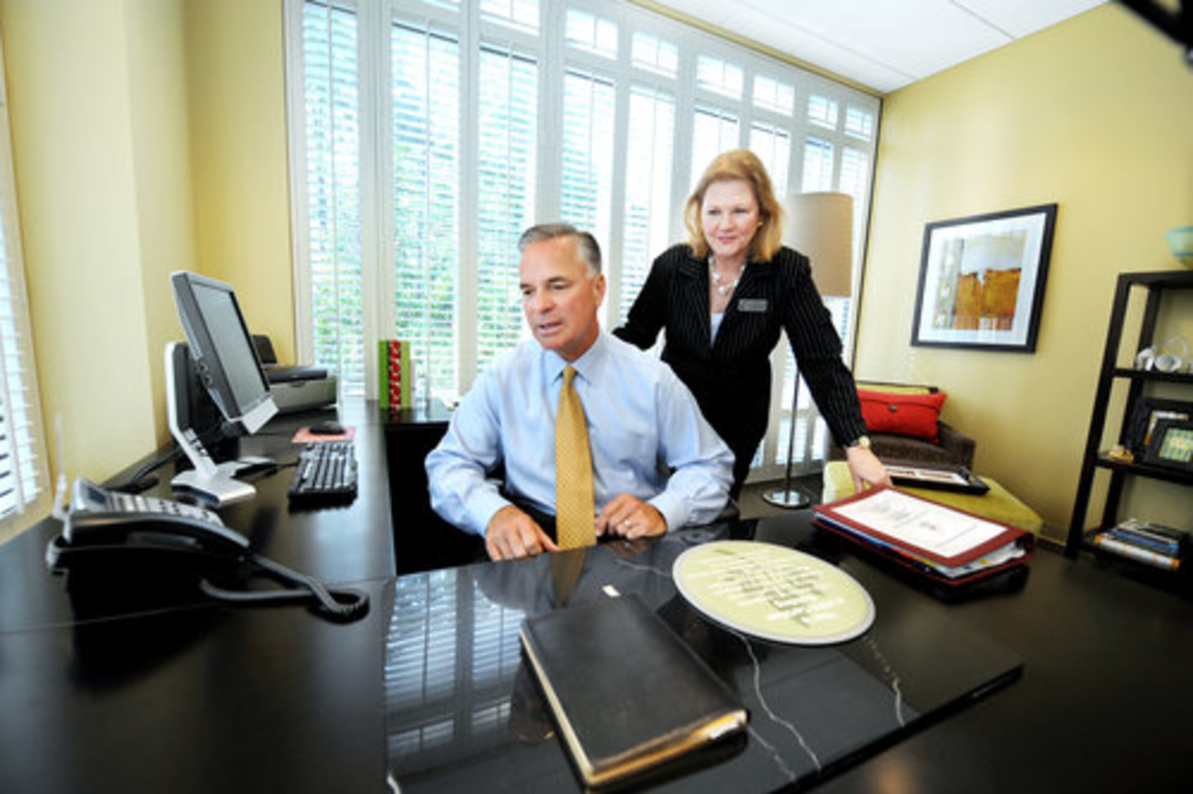Ralph Alvarez (left), President and C.O.O. of the McDonald Corporation, tries out the new digs in the office of Linda Morris (right). She is the Atlanta Ronald McDonald House Charities Executive Director.
