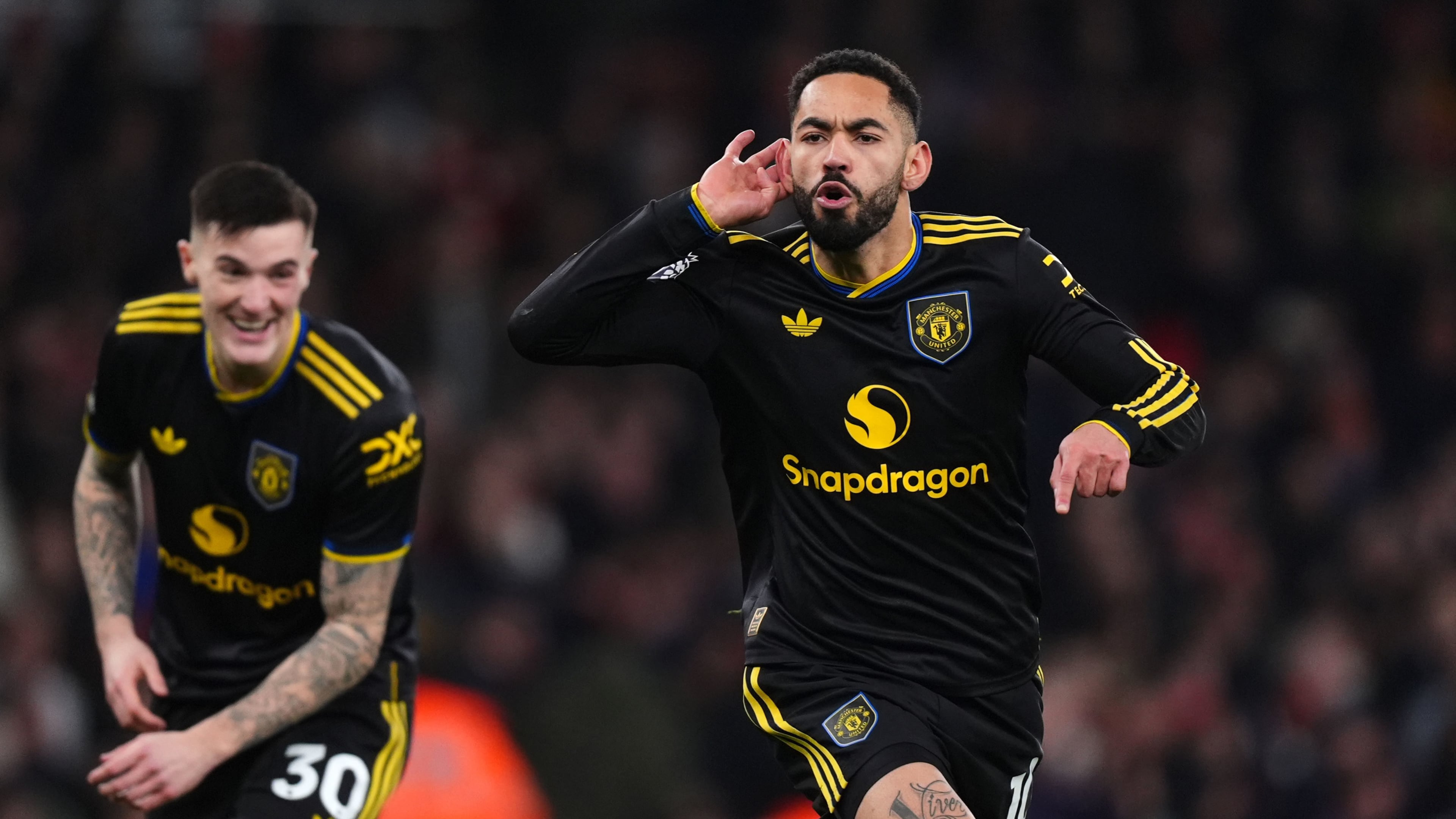 Manchester United's Matheus Cunha celebrates scoring their side's third goal of the game during the English Premier League soccer match between Arsenal and Manchester United in London, Sunday, Jan. 25, 2026. (Mike Egerton/PA via AP)