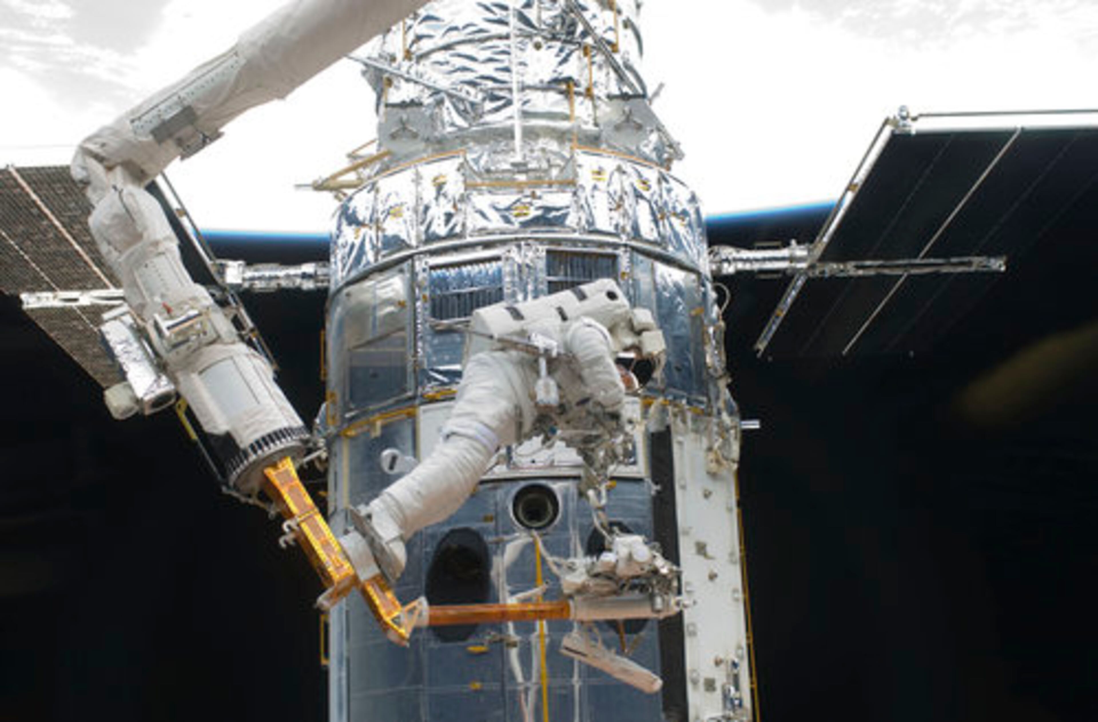 On Thursday, astronaut Andrew Feustel, mission specialist, performs work on the Hubble Space Telescope as the first of five STS-125 spacewalks kicks off a week's work on the orbiting observatory.