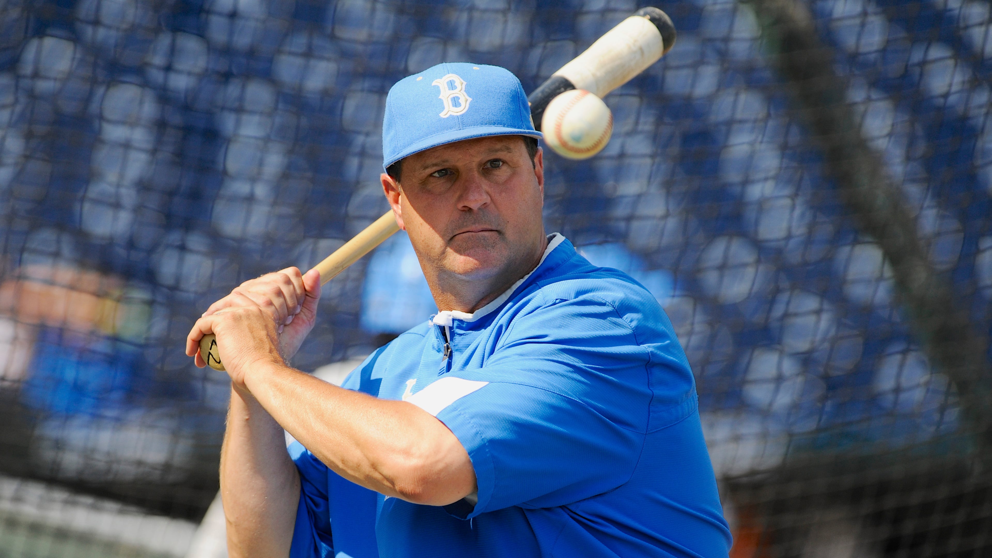 FILE - UCLA coach John Savage eyes the ball during NCAA college baseball practice June 14, 2013, in Omaha, Neb. (AP Photo/Eric Francis, File)
