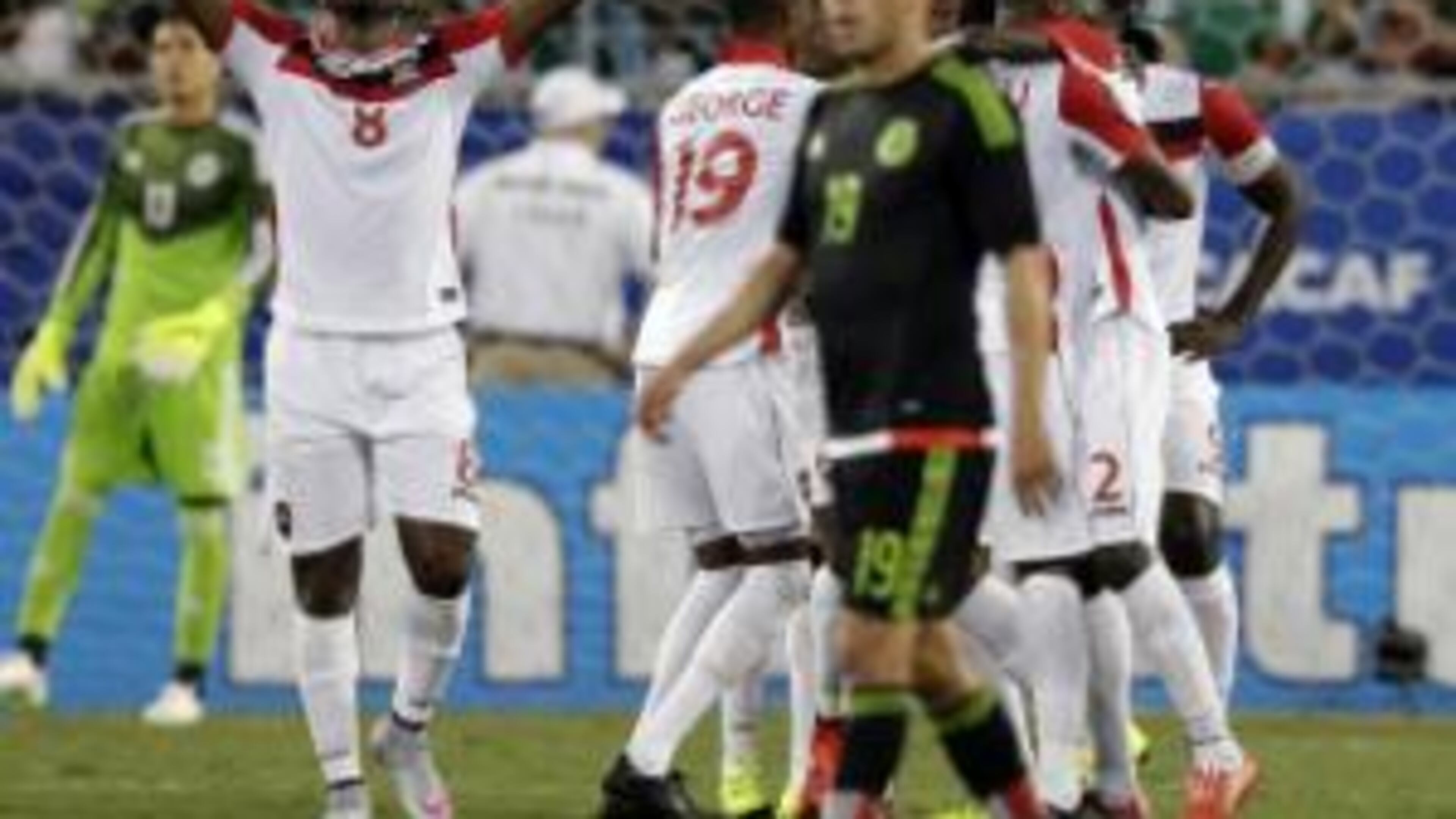 Trinidad and Tobago’s Khaleem Hyland (8) celebrates a teammate’s goal against Mexico during the second half of a CONCACAF Gold Cup soccer match in Charlotte, N.C., Wednesday. (AP Photo/Chuck Burton)