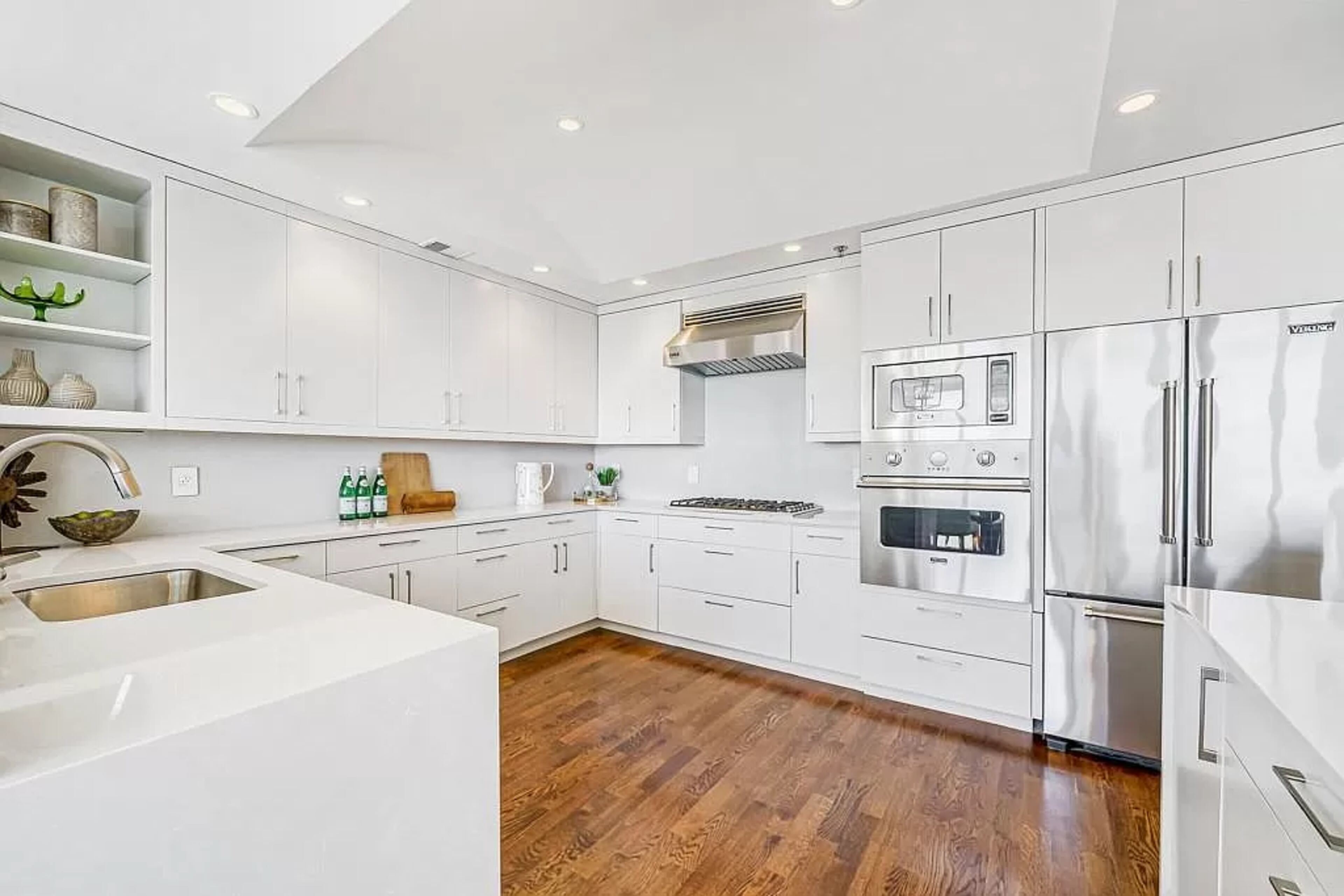 The high-end kitchen is sure to please any chef with its professional-grade Viking appliances, quartz countertops with waterfall edges and sleek slab cabinetry.