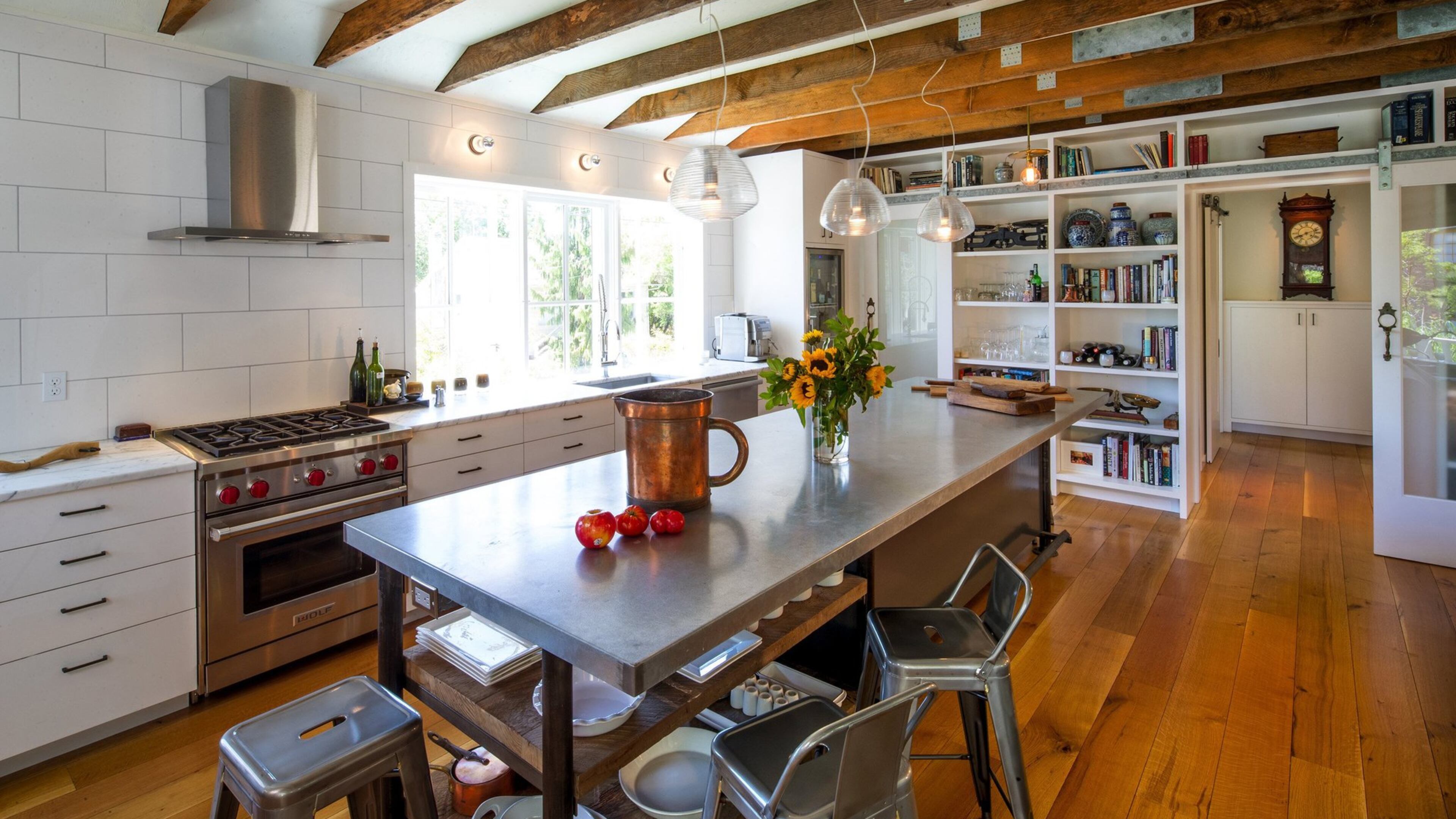 The bright, open great room is anchored by a sizable chef s table with salvaged planks underneath. It s a workhorse of function, and reads like a piece of furniture, says J.A.S. Design-Build designer Mike Freeman. The kitchen, to both of us, is a very, very important room, says homeowner Mary Speckart. We both love to cook; it s a must. And we entertain quite a bit; it s very conducive to parties. The wall at the rear closes off to the private wing of the home. (Mike Siegel/The Seattle Times/TNS)