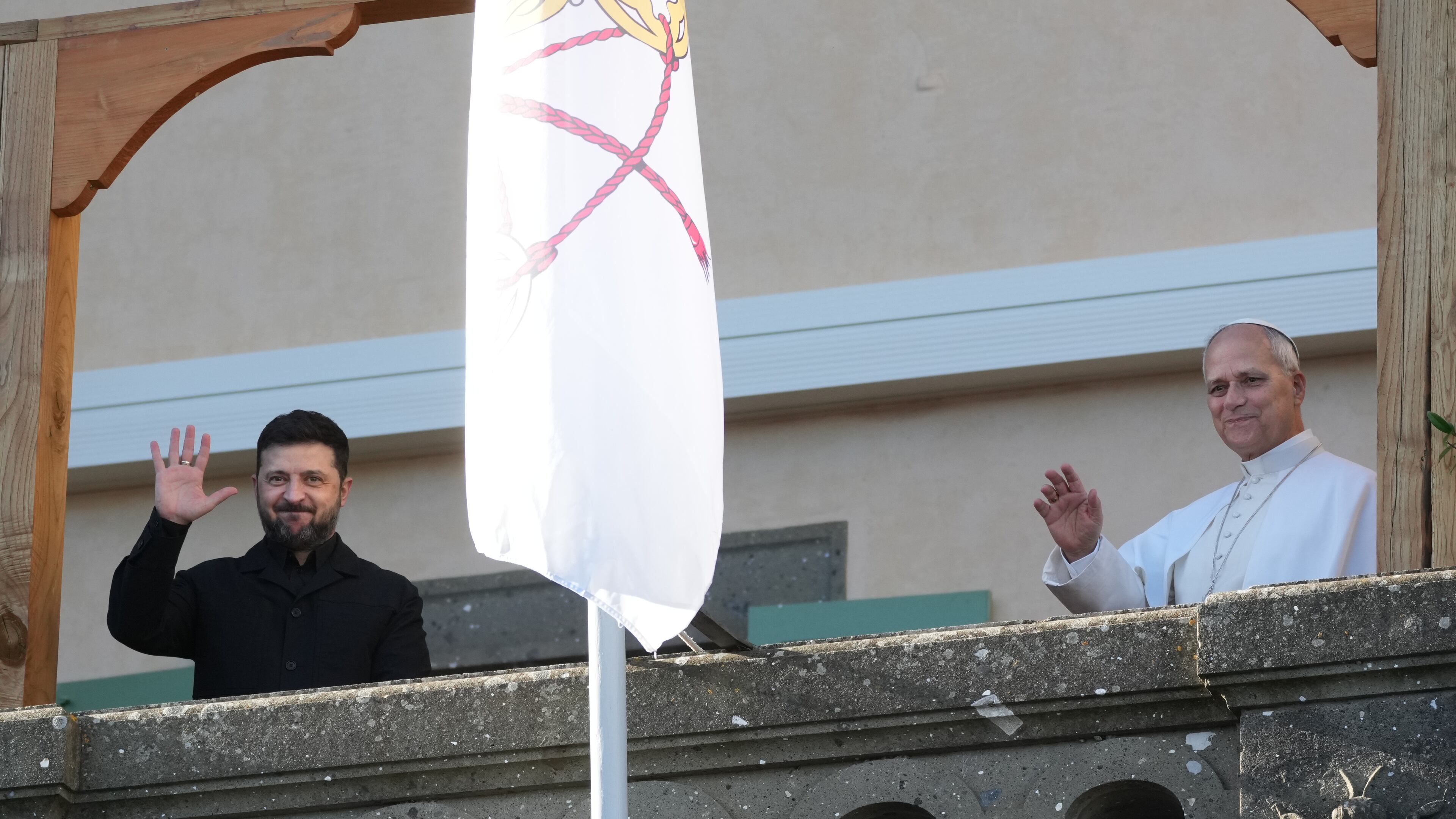 Ukraine's President Volodymyr Zelenskyy and Pope Leo XIV wave to journalists during their meeting in Castel Gandolfo, Italy, Tuesday, Dec. 9, 2025. (AP Photo/Andrew Medichini)