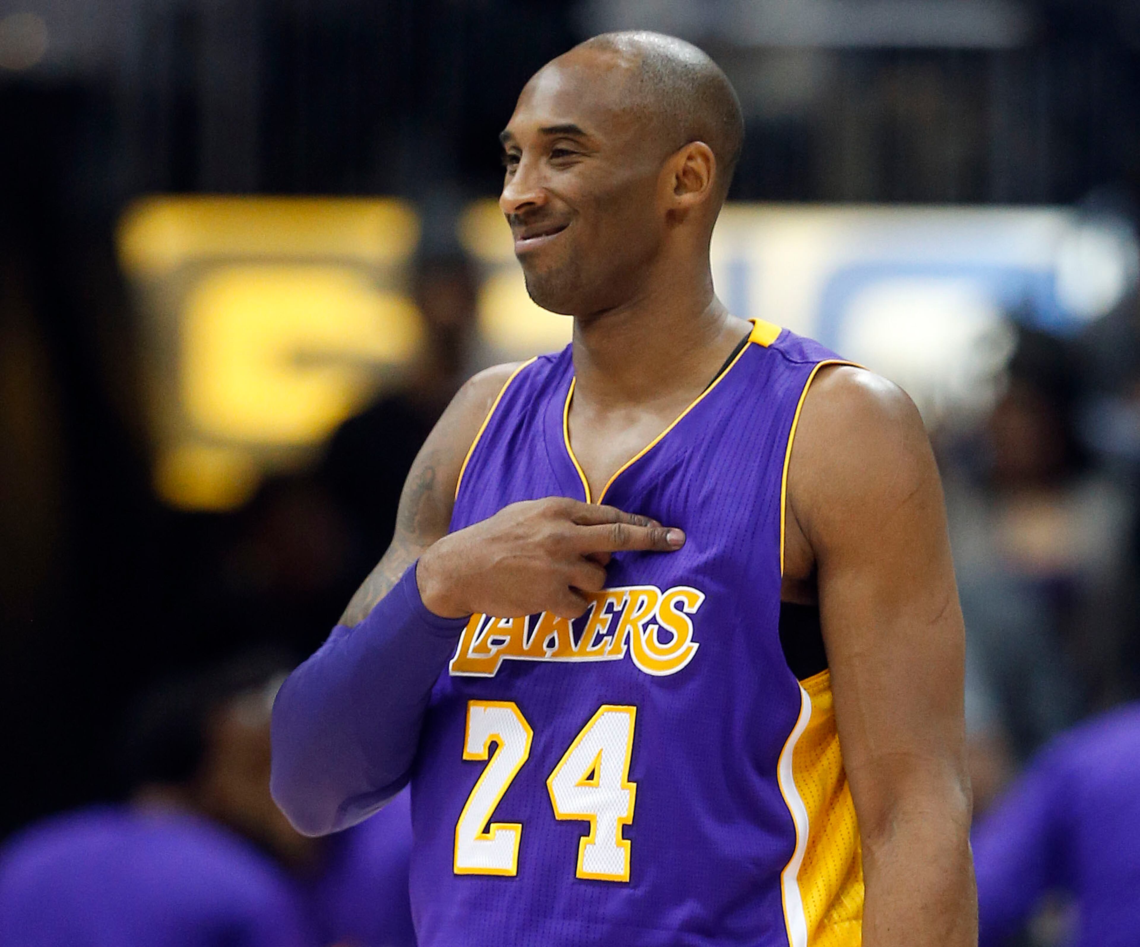 Los Angeles Lakers forward Kobe Bryant (24) gestures to someone in the crowd in the first half of an NBA basketball game against the Atlanta Hawks, Friday, Dec. 4, 2015, in Atlanta. Bryant has said he plans to retire at the end of the season. (AP Photo/John Bazemore)