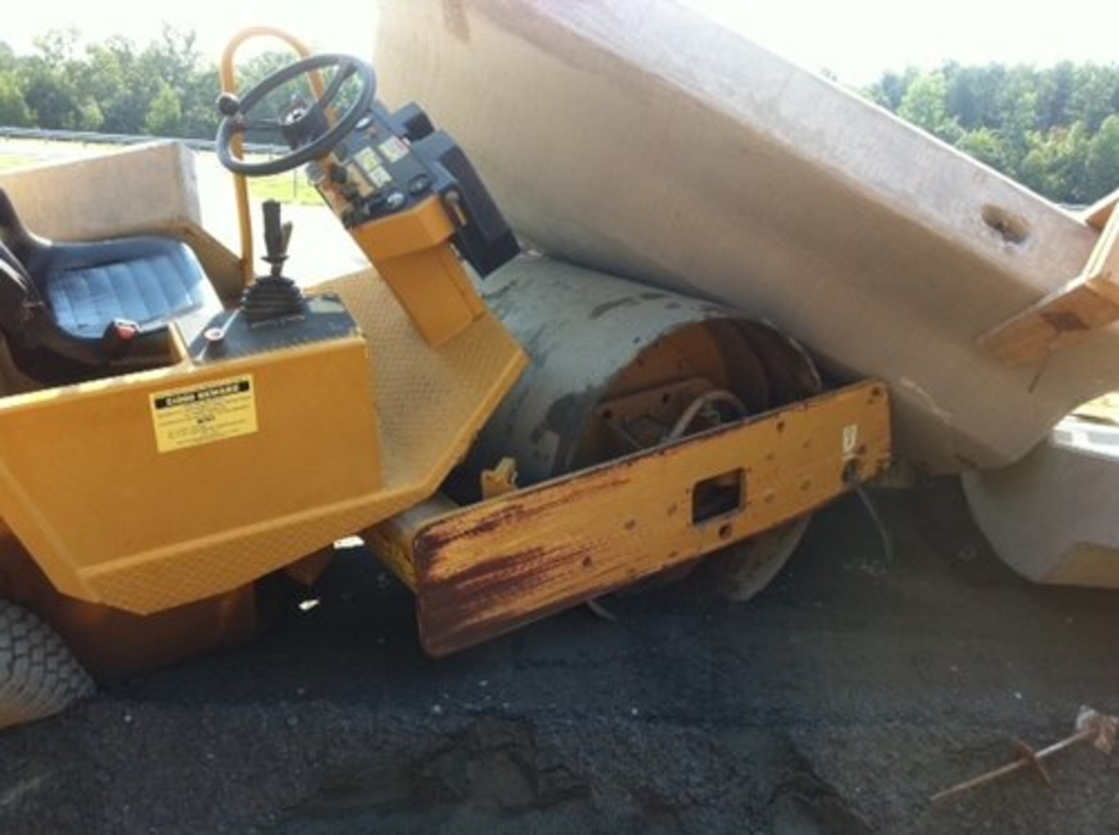The collapse of sections of a retaining wall near the planned Ridgewalk Parkway Bridge on southbound I-575 was possibly caused by a road construction roller used for grading and compacting dirt. One section of the wall landed on the roller.