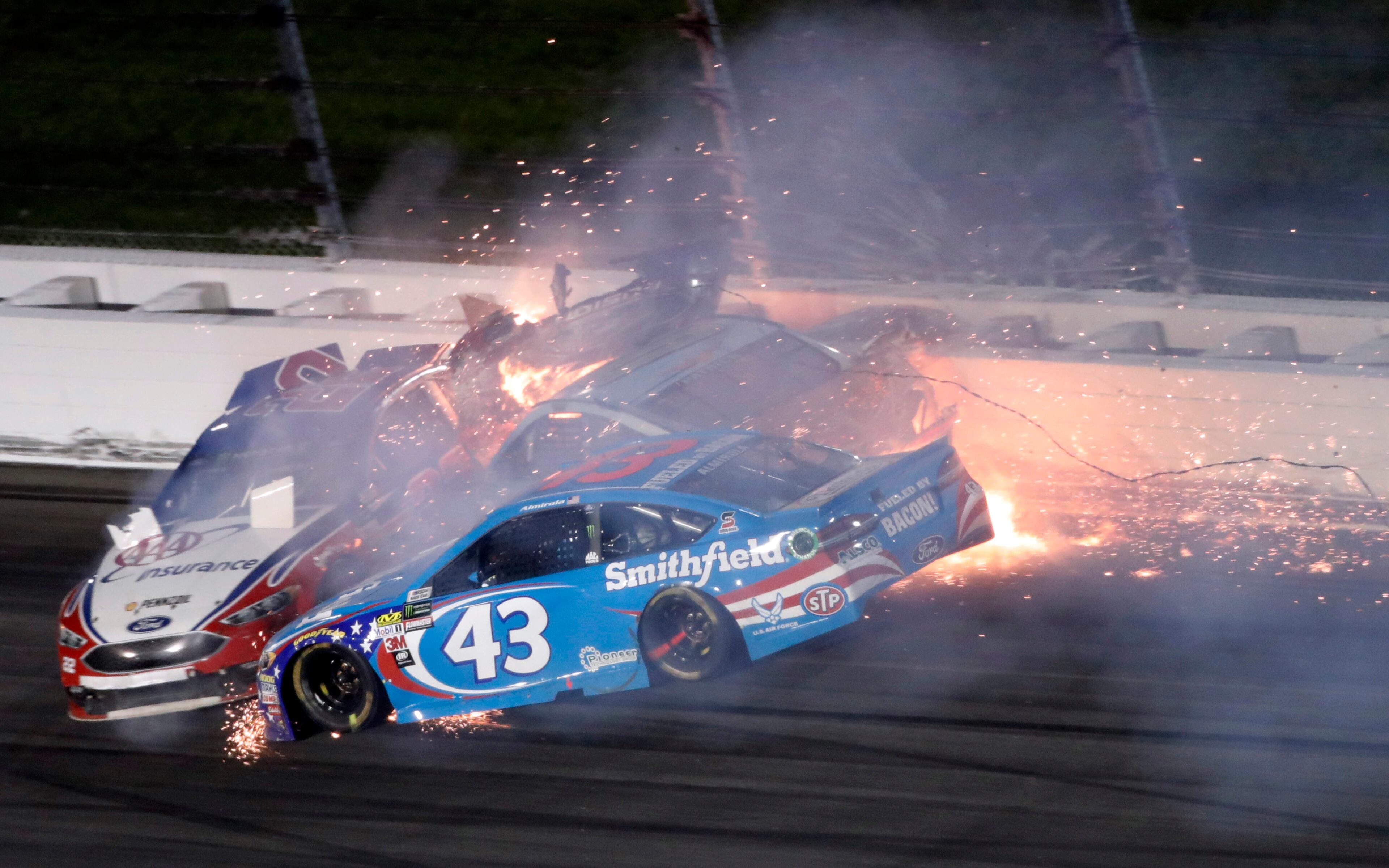 Aric Almirola (43) crashes into Danica Patrick and Joey Logano (22) during the NASCAR Monster Cup auto race at Kansas Speedway in Kansas City, Kan., Saturday, May 13, 2017. (AP Photo/Colin E. Braley)