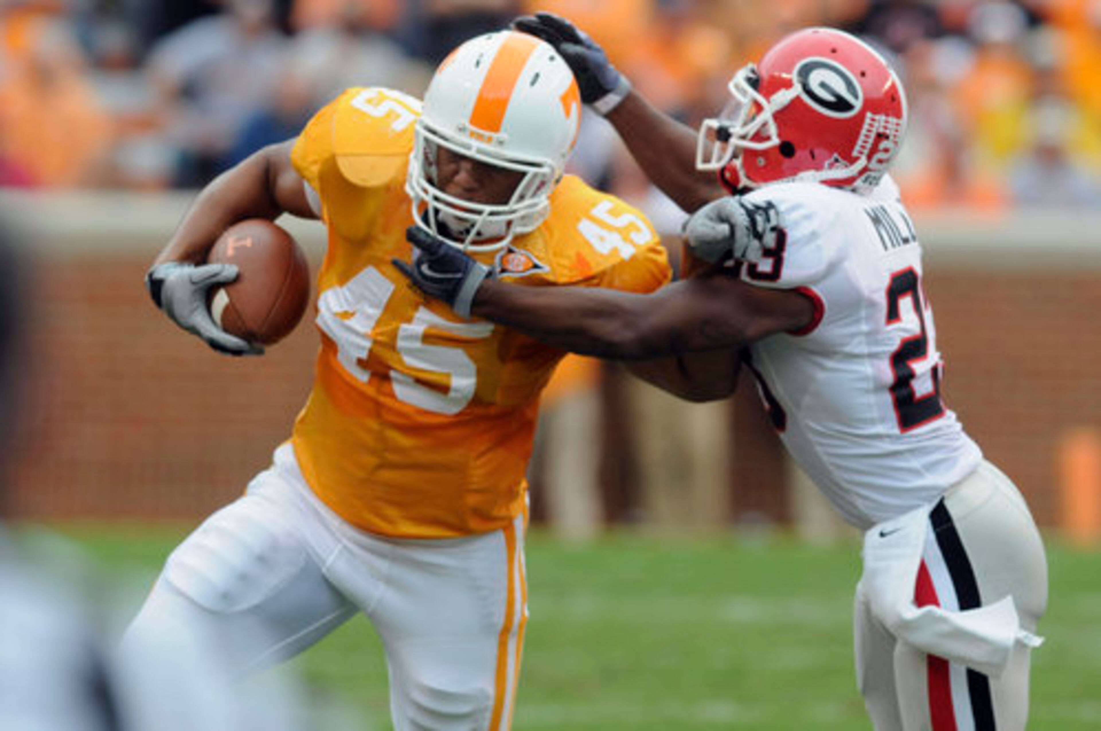 Georgia's Prince Miller tries to hold on as Tennessee's Kevin Cooper fights to avoid the tackle.