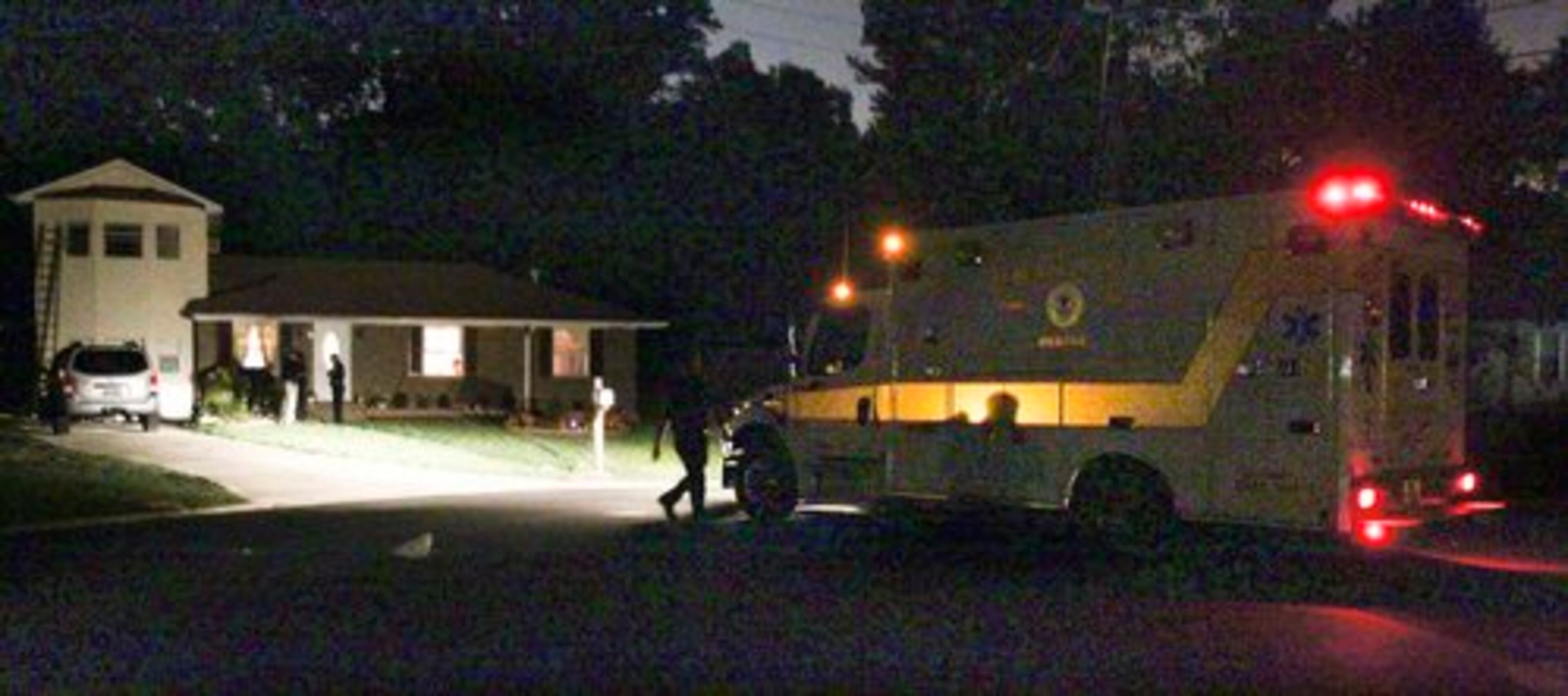 An ambulance pulls away from the scene where two people were shot overnight at a home in Clayton County.