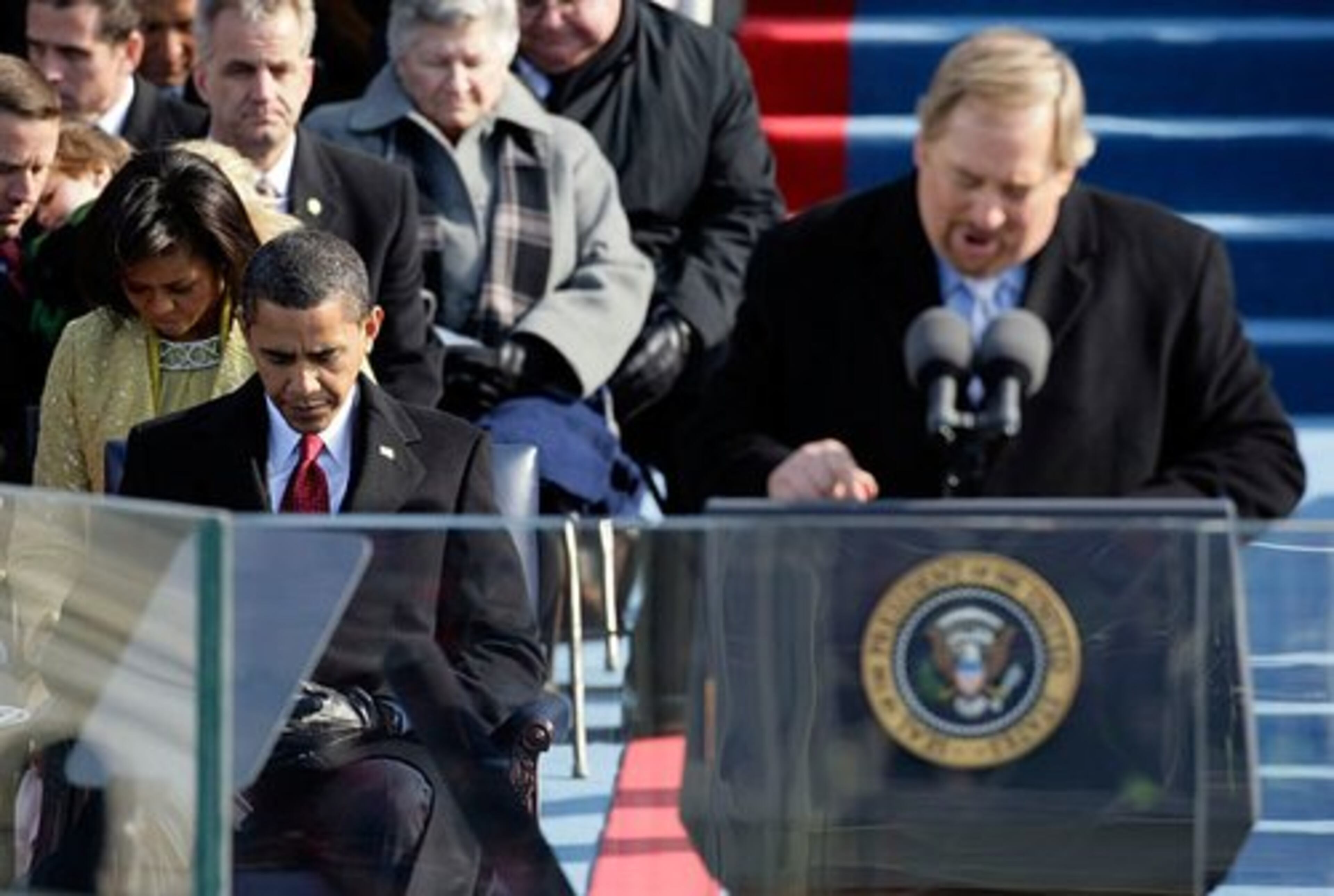 Obama bows his head during the invocation by the Rev. Rick Warren at the inauguration.