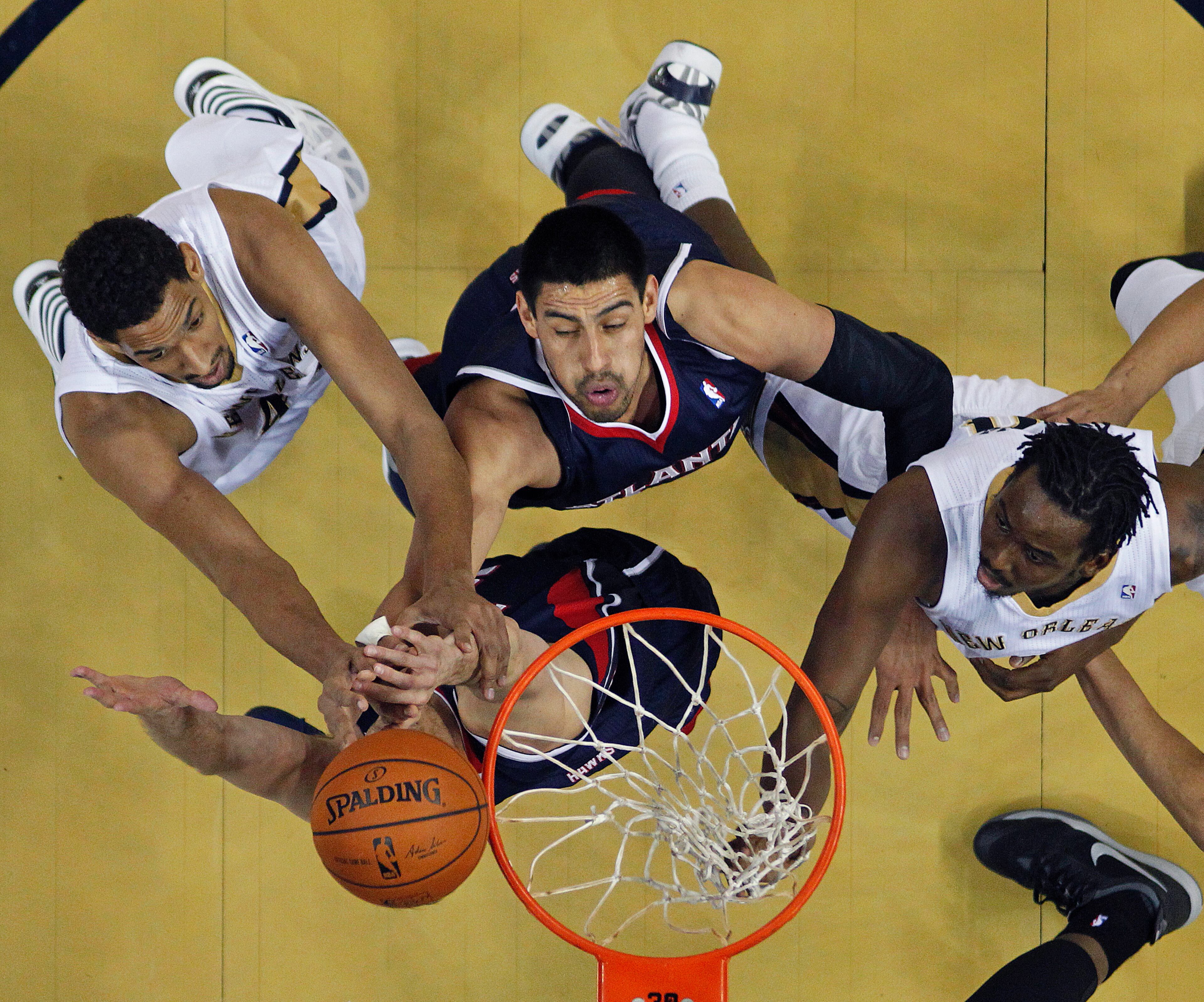 Atlanta Hawks power forward Gustavo Ayon, top center, and shooting guard Kyle Korver, bottom center, battle for the ball with New Orleans Pelicans center Alexis Ajinca, left, and small forward Al-Farouq Aminu, right, in the first half of an NBA basketball game in New Orleans, Wednesday, Feb. 5, 2014. (AP Photo/Gerald Herbert)