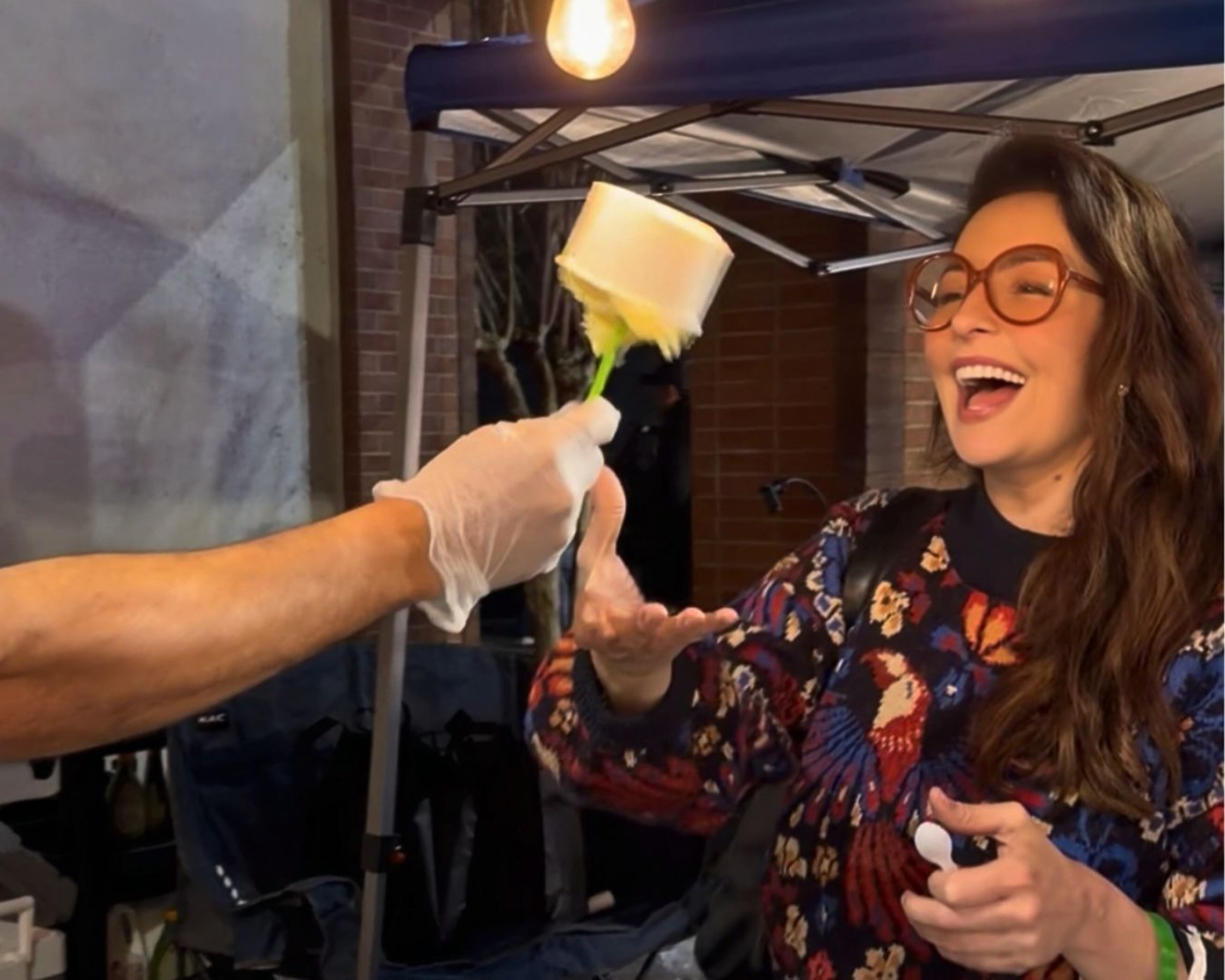 AJC Senior food editor Monti Carlo laughs as she tries to grab booza from a vendor who is teasing her, as is traditional, by refusing to hand over the ice cream. (Courtesy of Monti Carlo)