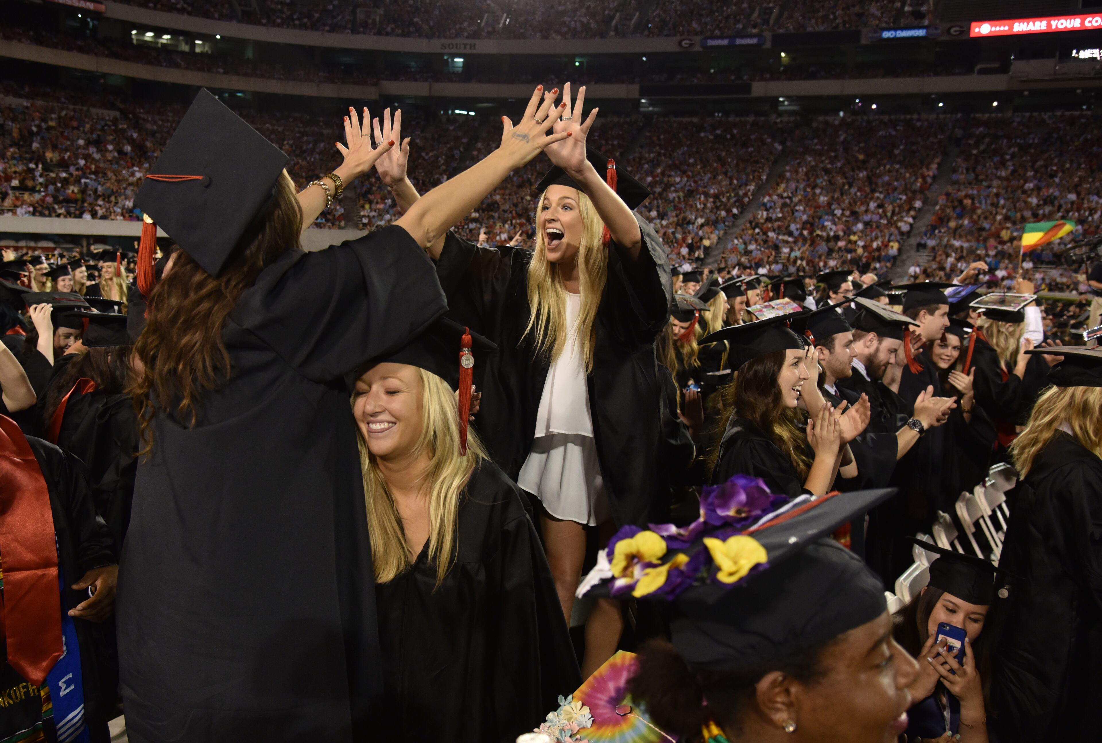 UGA graduates celebrate after their degrees were conferred during the Spring Commencement Ceremony May 13, 2016. "American Idol" host Ryan Seacrest delivered he Commencement address in addition to receiving an honorary Doctor of Humane Letters degree. Seacrest, who grew up in Dunwoody, attended UGA briefly before pursuing a broadcasting career. More than 5,500 graduates were eligible to participate in the ceremony. BRANT SANDERLIN/BSANDERLIN@AJC.COM