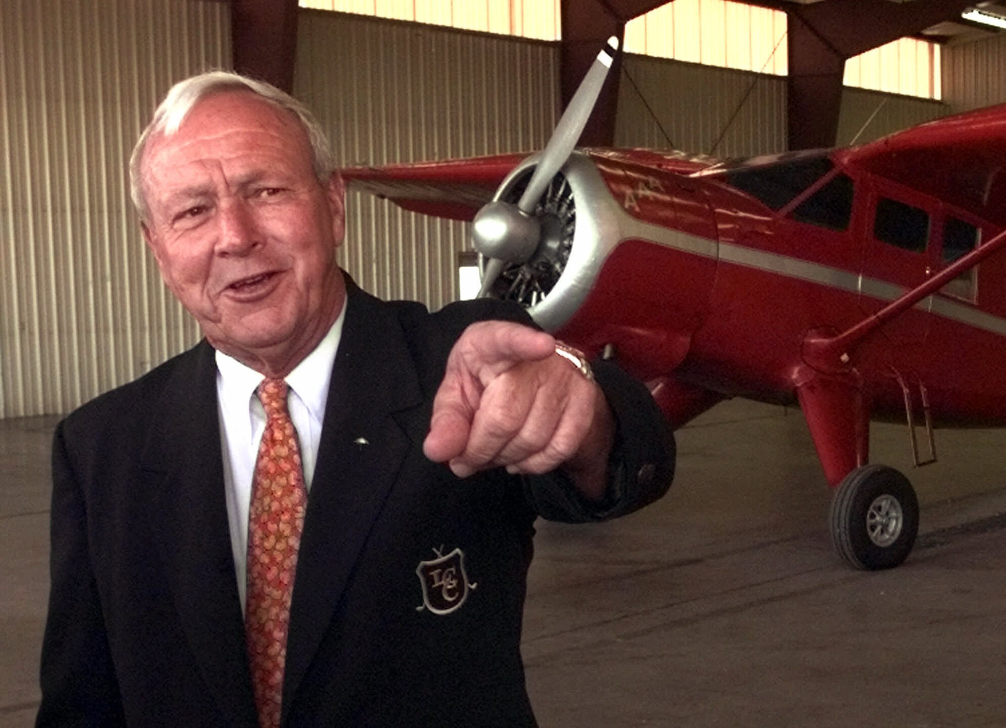 Golf legend Arnold Palmer poses with a plane used to deliver Air Mail that first sparked his interest in aviation. He made his final flight as pilot-in-command in 2011 after more than 55 years and 20,000 hours in the cockpit. (AP Photo/Gene J. Puskar,file)