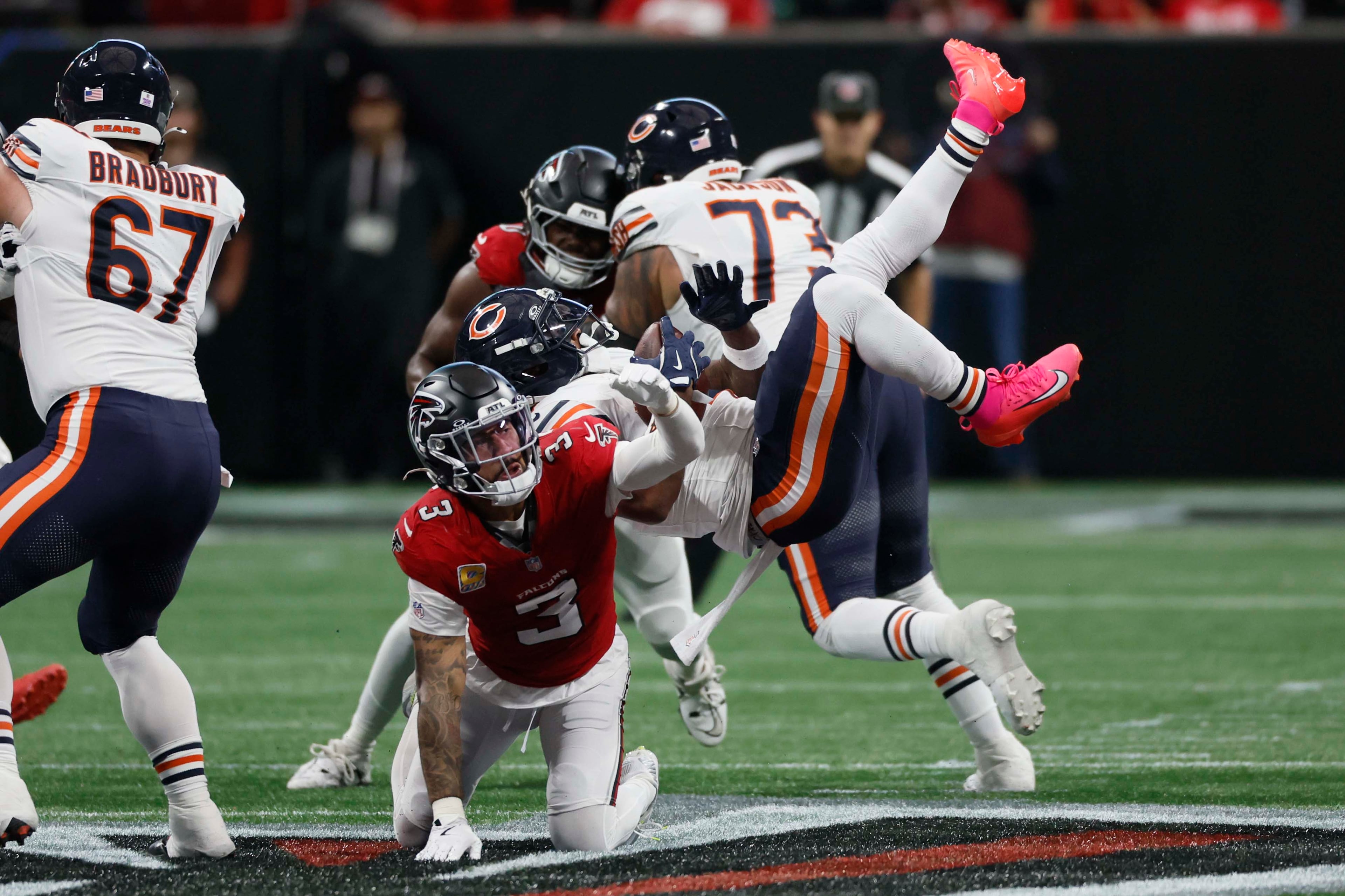 Atlanta Falcons free safety Jessie Bates (second from left) tackles Chicago Bears running back D’Andre Swift in the second half of an NFL game against the Chicago Bears at Mercedes-Benz Stadium in Atlanta on Sunday, Oct. 18, 2026. (Miguel Martinez/AJC)