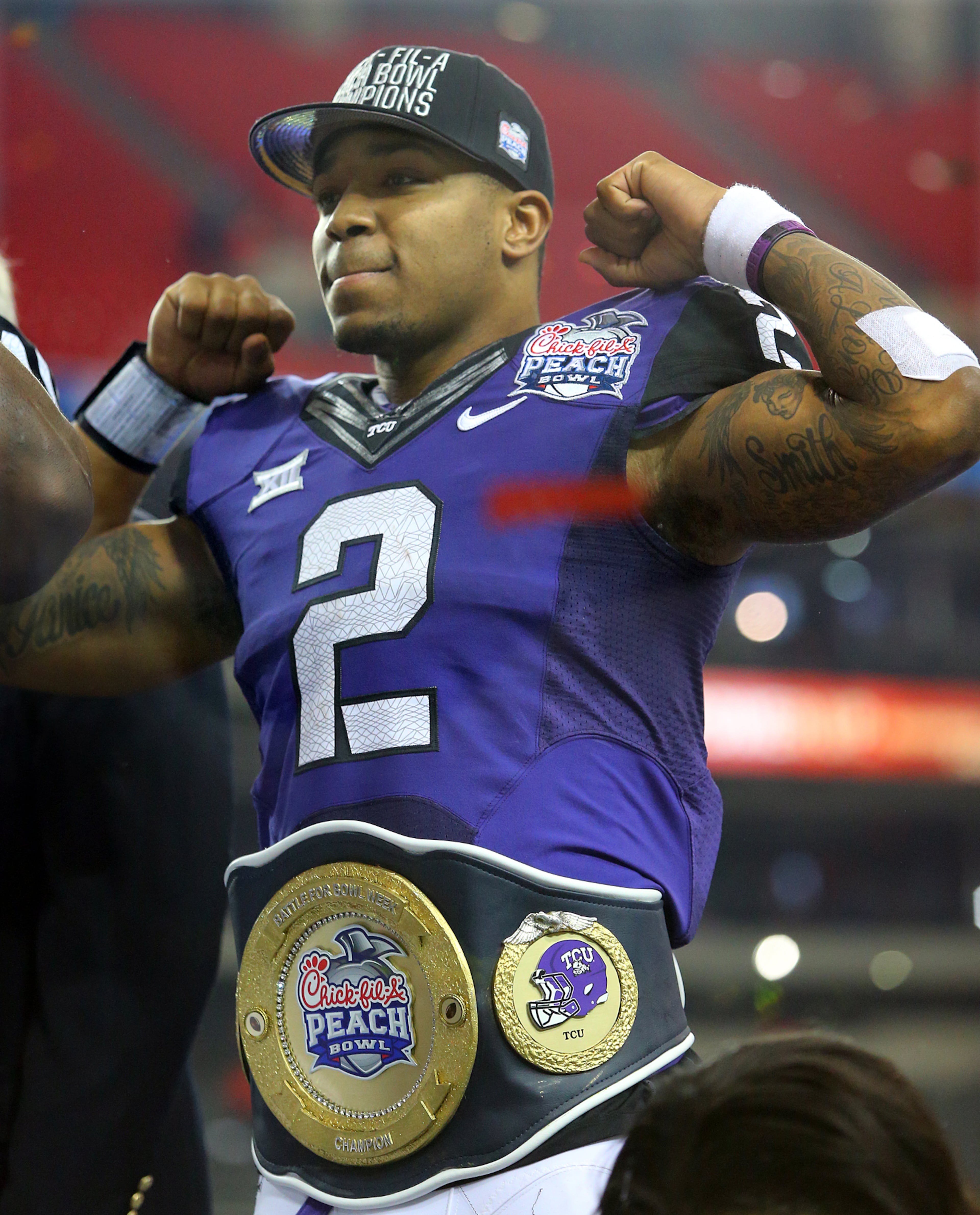 Offensive player of the game TCU quarterback Trevone Boykin flexes on stage after beating Ole Miss 42-3 to win the Chick-fil-A Peach Bowl on Wednesday, Dec. 31, 2014, in Atlanta. Curtis Compton / ccompton@ajc.com