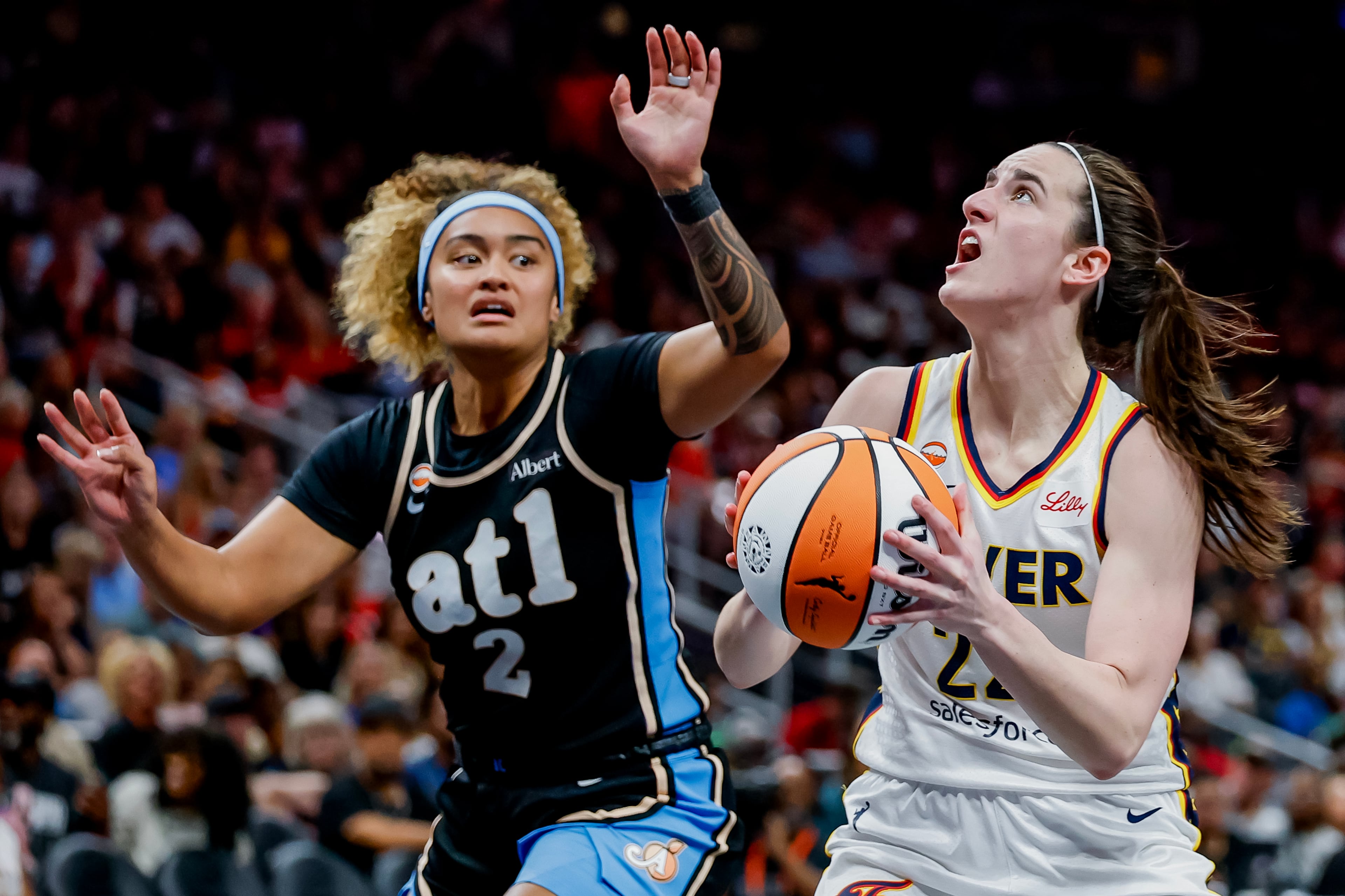 Clark (right) drives against Dream guard Te-Hina Paopao. (Erik S. Lesser for the AJC)