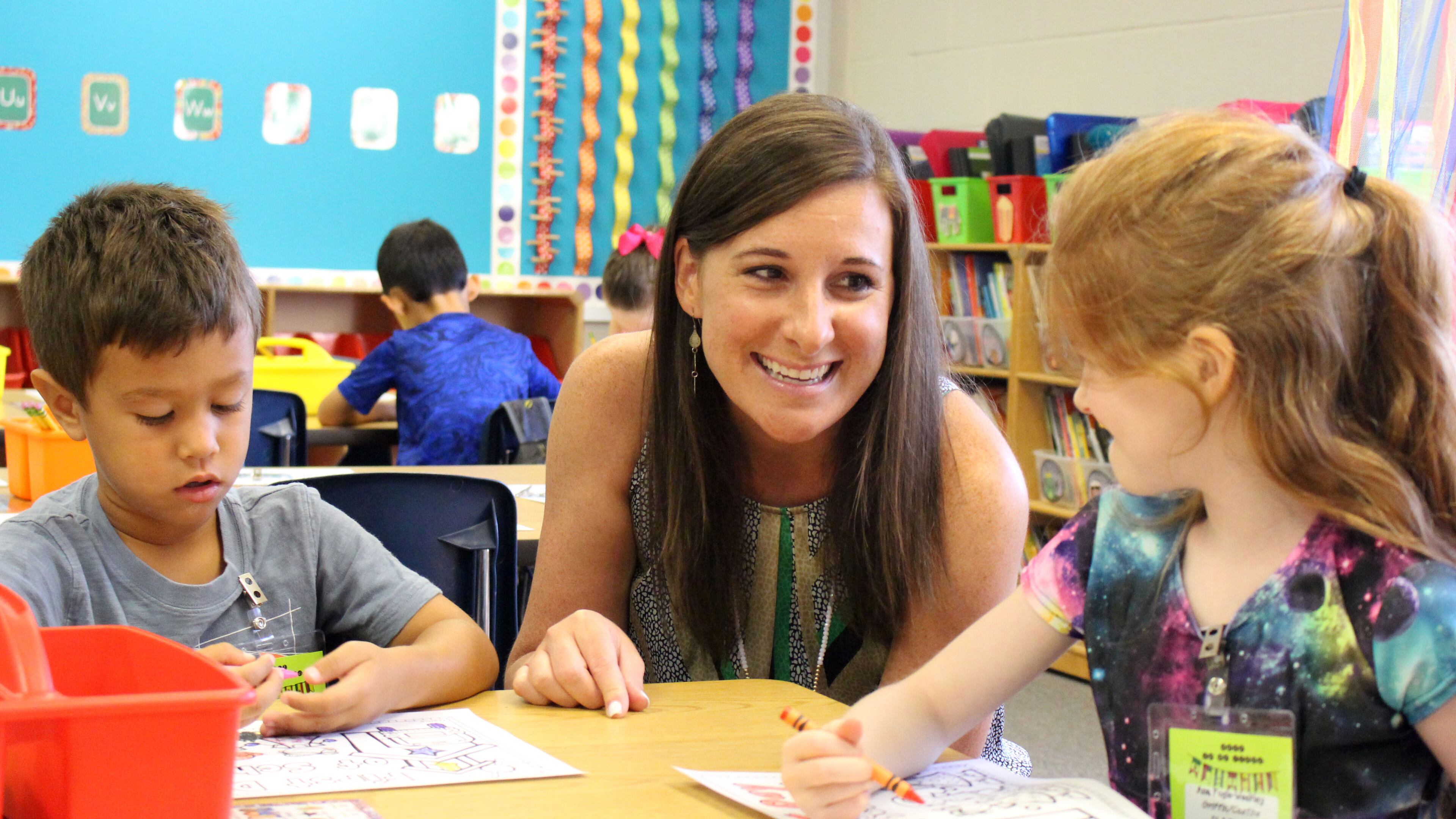 8/6/18 - Suwanee - Kerri Griffin, a kindergarten teacher at Level Creek Elementary School, talks to her students, Ana Fogle-Weekley and Owen DeGeorge, during the first day of school at Level Creek Elementary School on Monday, August 6. Griffin teaches one of the dual language immersion classes. Jenna Eason / Jenna.Eason@coxinc.com