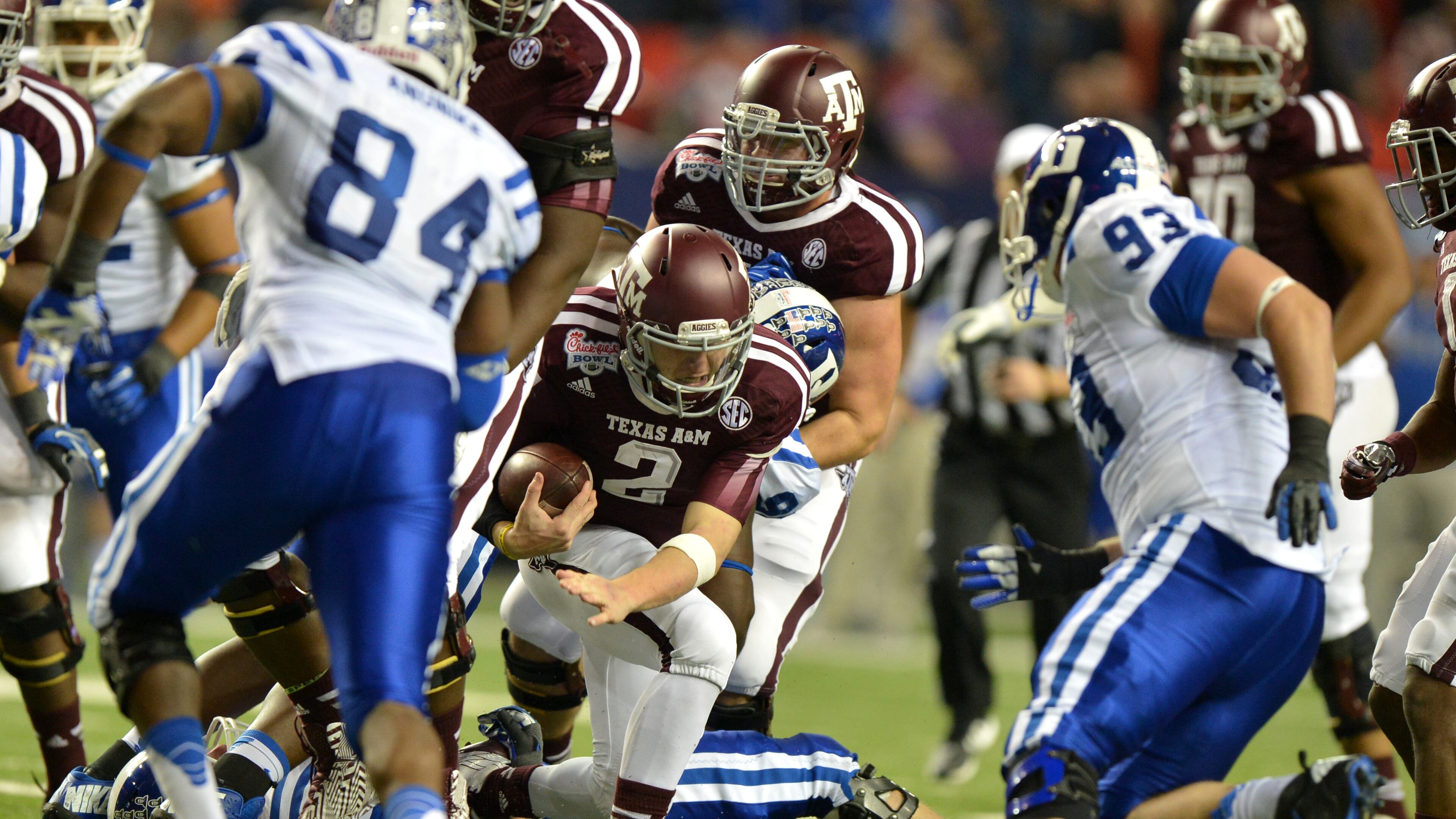 Texas A&M quarterback Johnny Manziel was able to escape trouble and complete a touchdown pass on this play during the 3rd quarter against Duke in the Chick-fil-A Bowl Tuesday Dec. 31, 2013. BRANT SANDERLIN /BSANDERLIN@AJC.COM