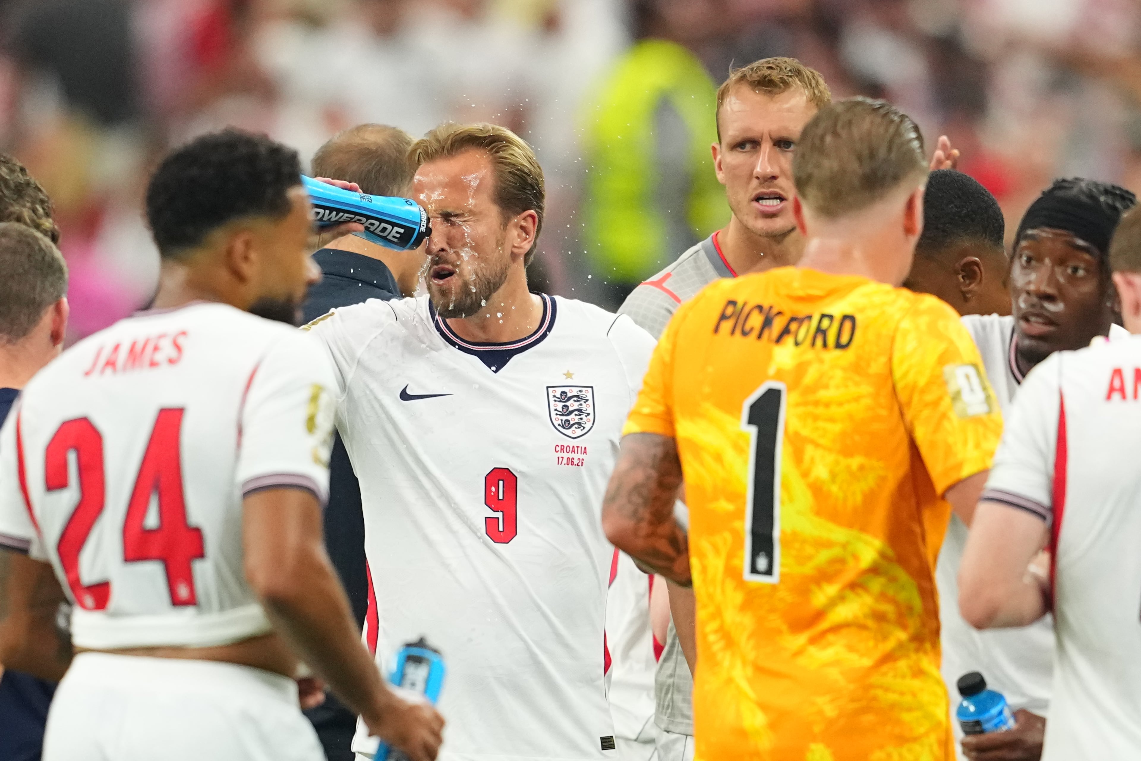 England's Harry Kane demonstrates the importance of hydration breaks. (Julio Cortez/AP)