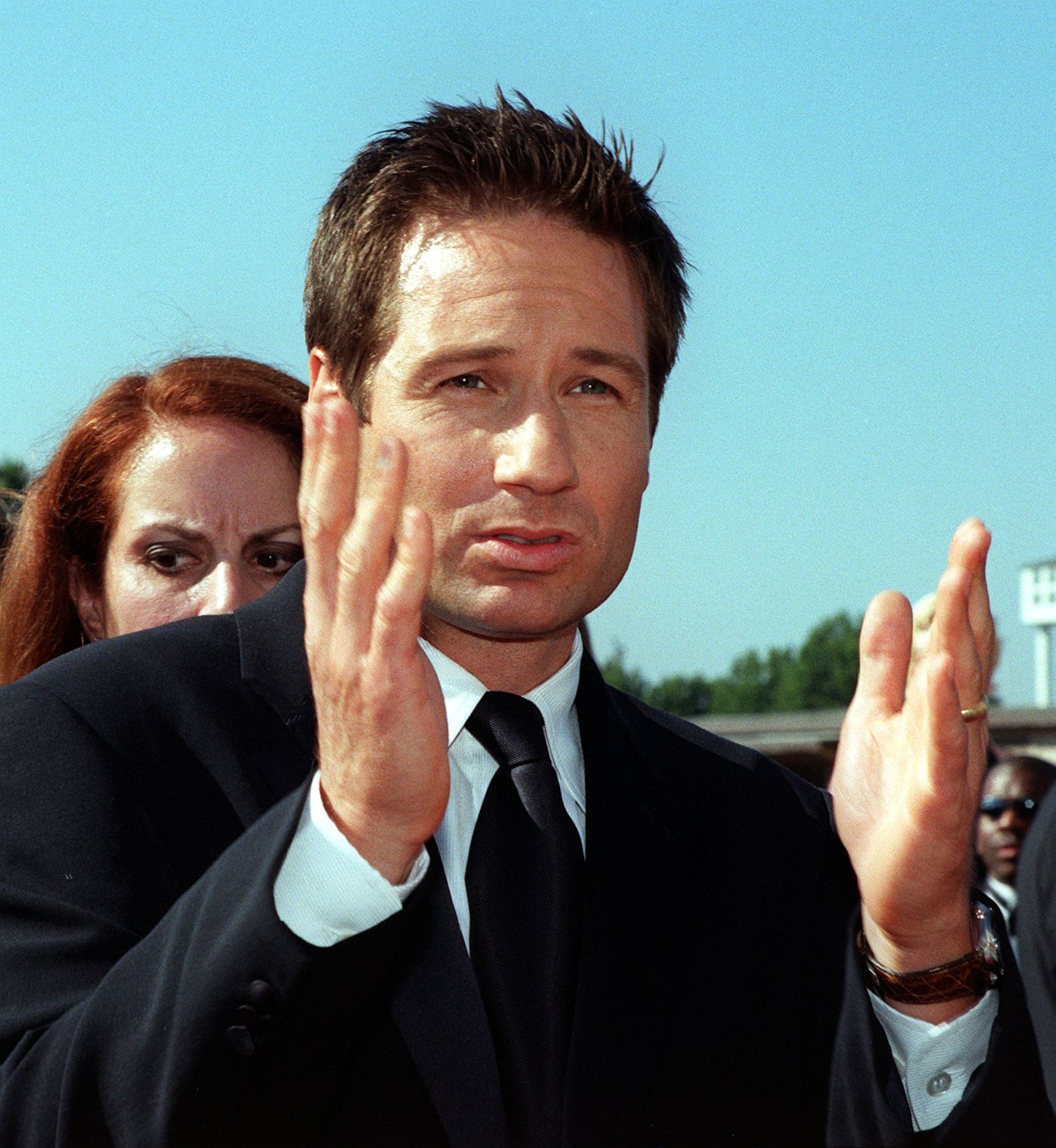 LOS ANGELES, UNITED STATES: Actor David Duchovny gestures as he arrives at the 50th Annual Primetime Emmy Awards 13 September at the Shrine Auditorium in Los Angeles. Duchovny is nominated for an Emmy for Outstanding Lead Actor in a Drama Series for his role as Fox Mulder in "The X-Files". AFP PHOTO Lucy NICHOLSON/mn (Photo credit should read LUCY NICHOLSON/AFP/Getty Images)