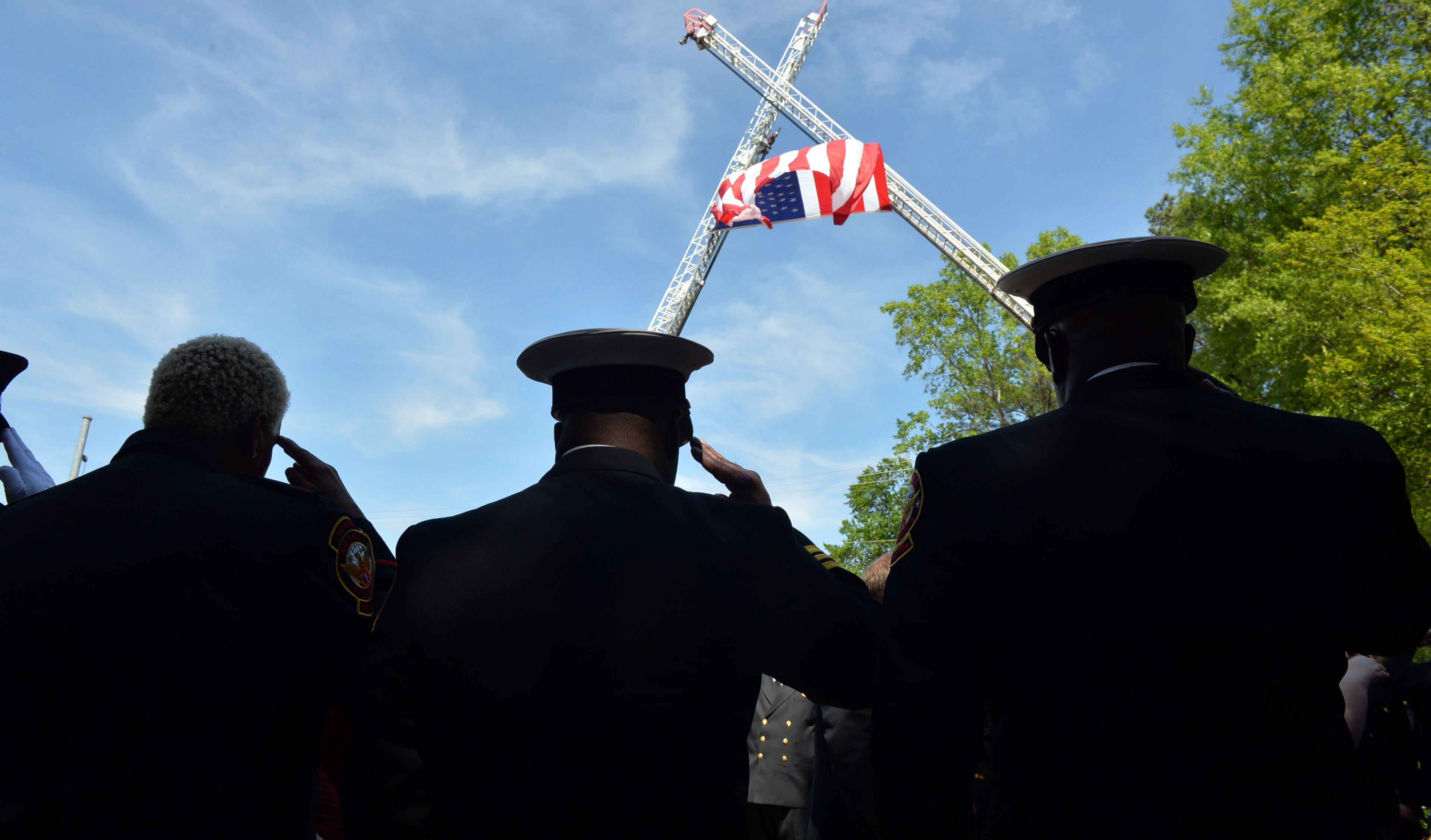 Atlanta Fire Rescue officials and firefighters salute as the casket leaves the church. They joined with family and friends during the funeral of AFR Sgt. Frank Guinn at Peachtree Road Presbyterian Church, Thursday, April 17, 2014. Sgt. Guinn, 36, was training for an Ironman Triathlon in New Orleans when he was struck on his bicycle and killed. Guinn, a nine-year veteran of the department, was stationed at Fire Station 21. He is survived by his wife, a Cobb County teacher, and 7-year-old triplet daughters.
