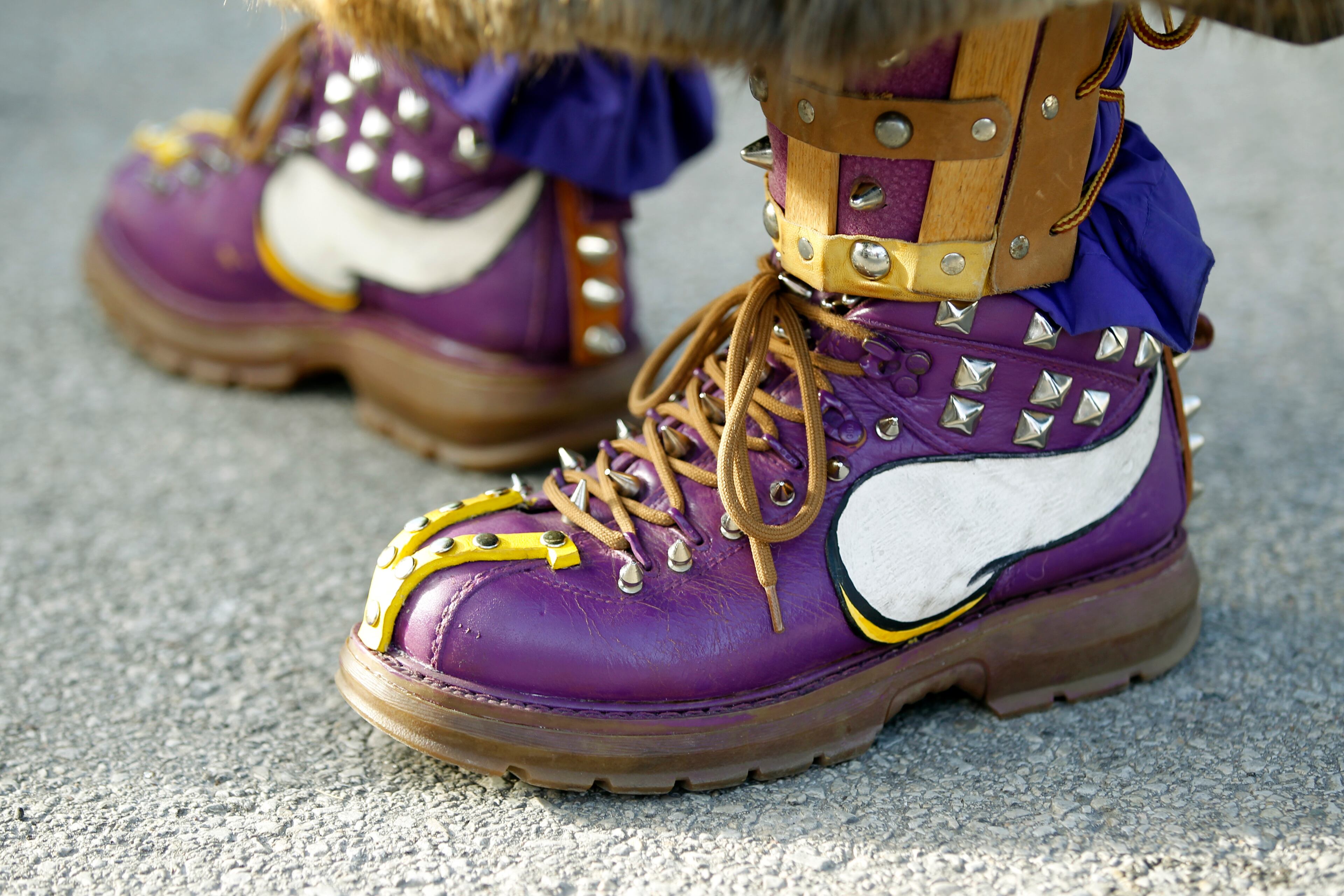 A Minnesota Vikings fan has his boots decorated before an NFL football game against the Green Bay Packers Sunday, Nov. 24, 2013, in Green Bay, Wis. (AP Photo/Mike Roemer)