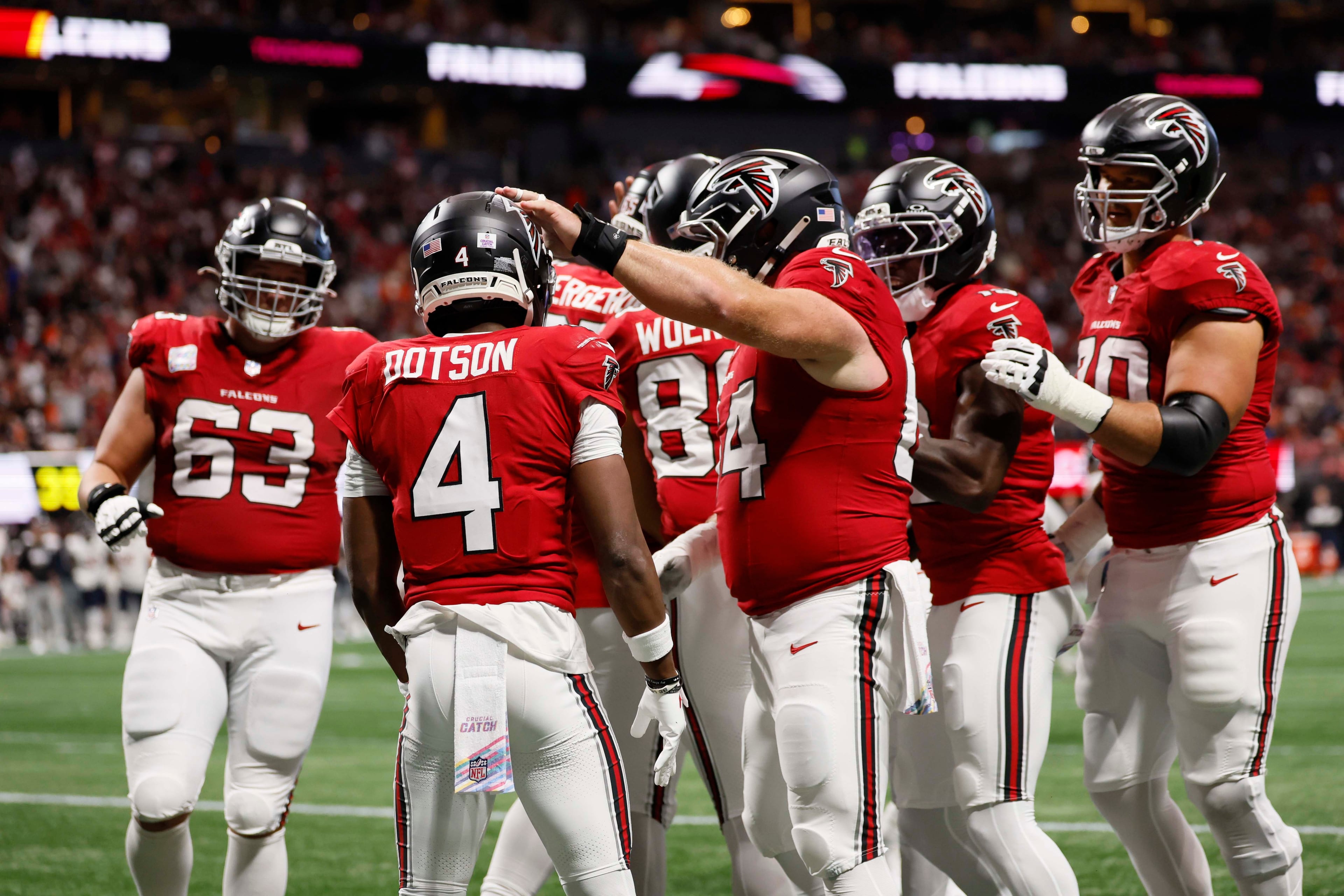 Atlanta Falcons players celebrate after wide receiver Jahan Dotson (second from left) scores a touchdown during the first half of an NFL football game against the Chicago Bears at Mercedes-Benz Stadium in Atlanta on Sunday, Oct. 18, 2026. (Miguel Martinez/AJC)