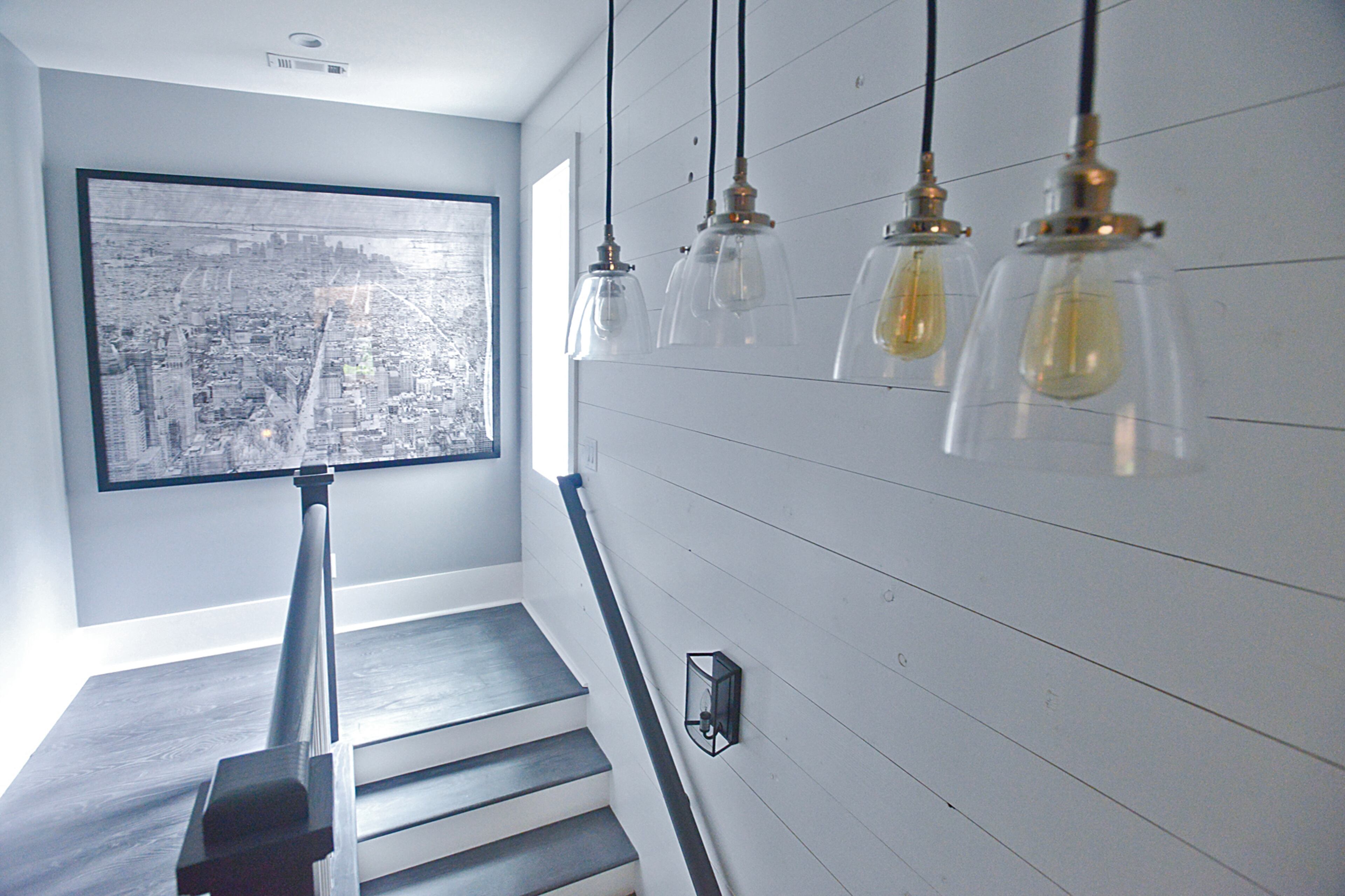 Period trim and shiplap walls mix with the more contemporary gray color scheme throughout the home in what homeowner Lauren Kane calls a "classic contemporary" style for her home in the Serenbe community south of Atlanta.