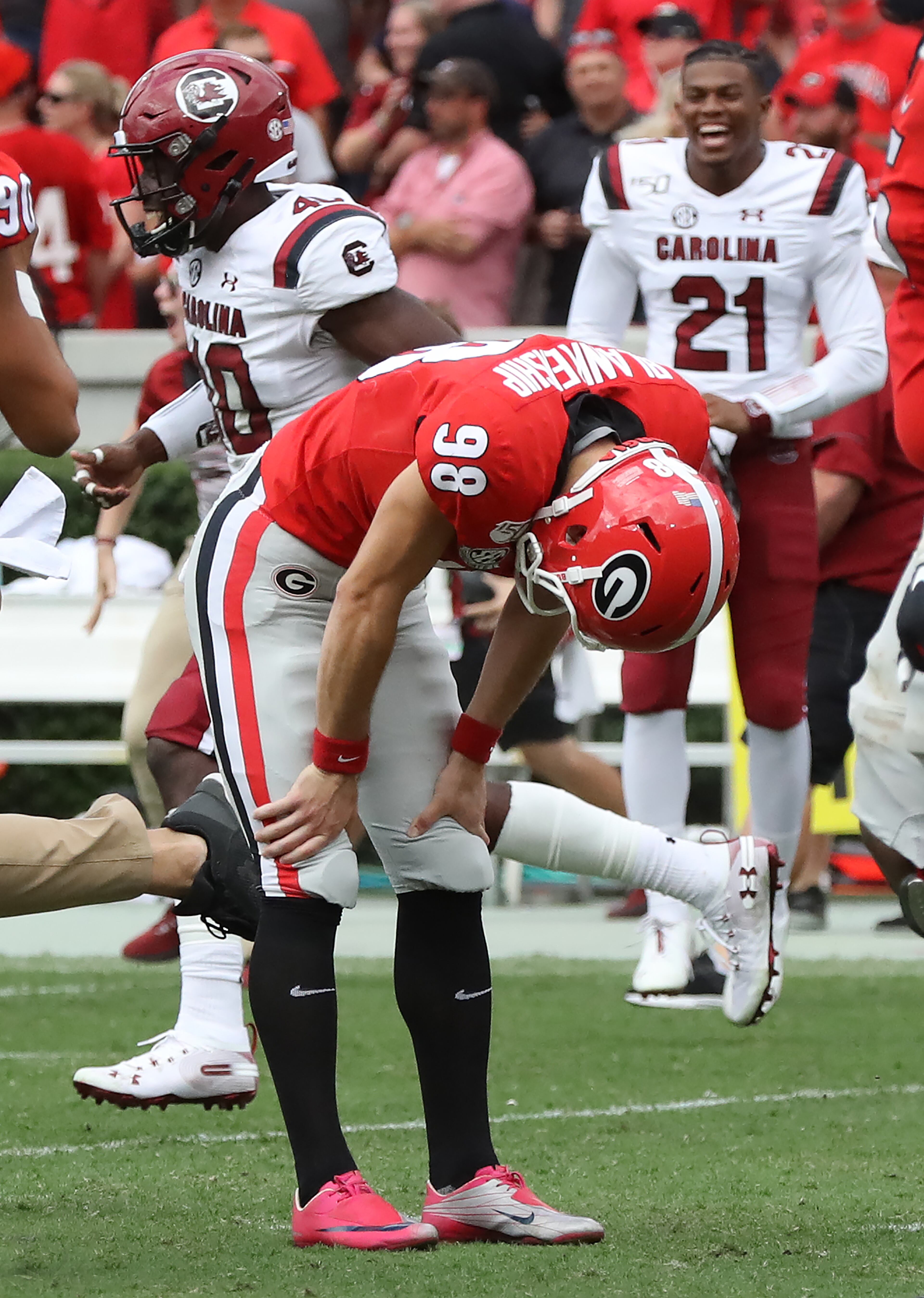 Georgia kicker Rodrigo Blankenship bends over dejectedly, reacting to missing his field goal attempt in double overtime as the Bulldogs lost to South Carolina 20-17 Saturday in Athens. Curtis Compton/ccompton@ajc.com