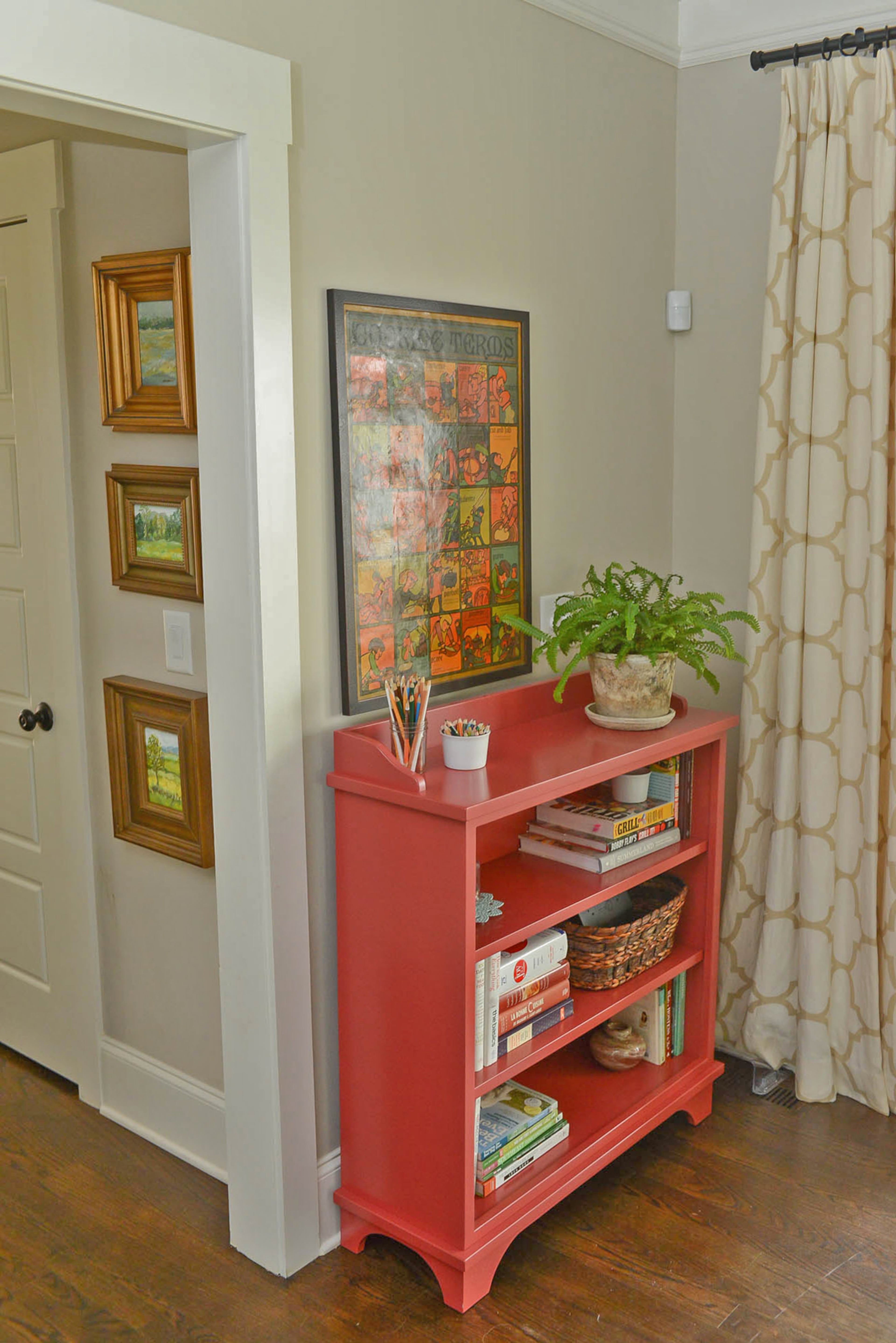 A custom bookcase by Trinity Mercantile & Design in Decatur sits in the kitchen as one of the touches of red Kate’s sprinkled through her kitchen and dining area. The framed vintage print with French cooking terms belonged to her grandmother.