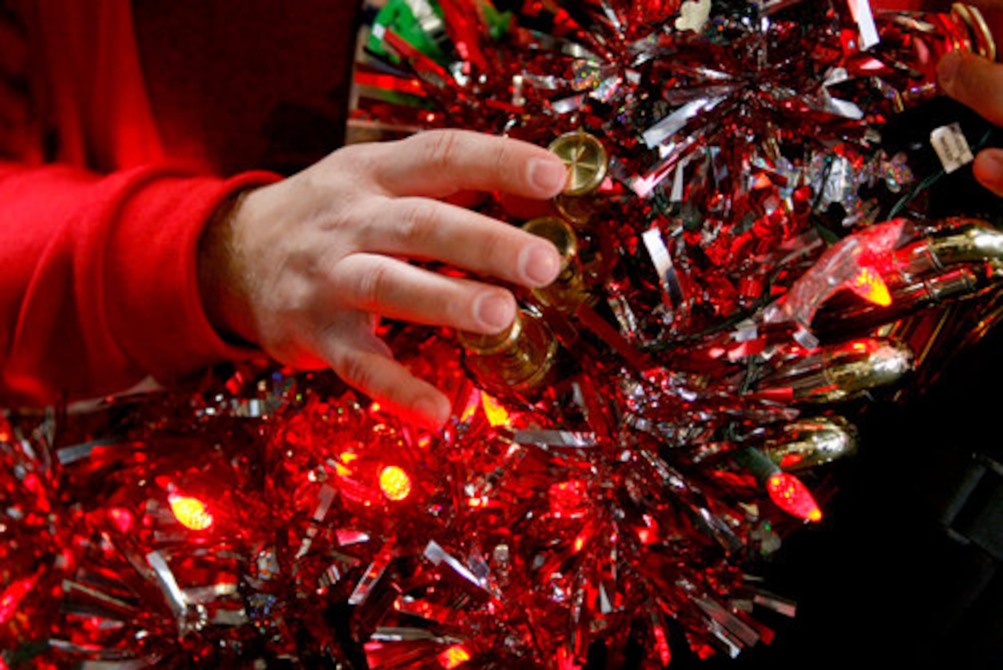 Cliff Norris of Atlanta belts out some notes on his susaphone with lit Christmas lights Friday at practice. Some 200 musicians ranging from eleven to seventy one years of age came together Friday, Dec. 4, 2009 for TUBACHRISTMAS at Underground Atlanta.