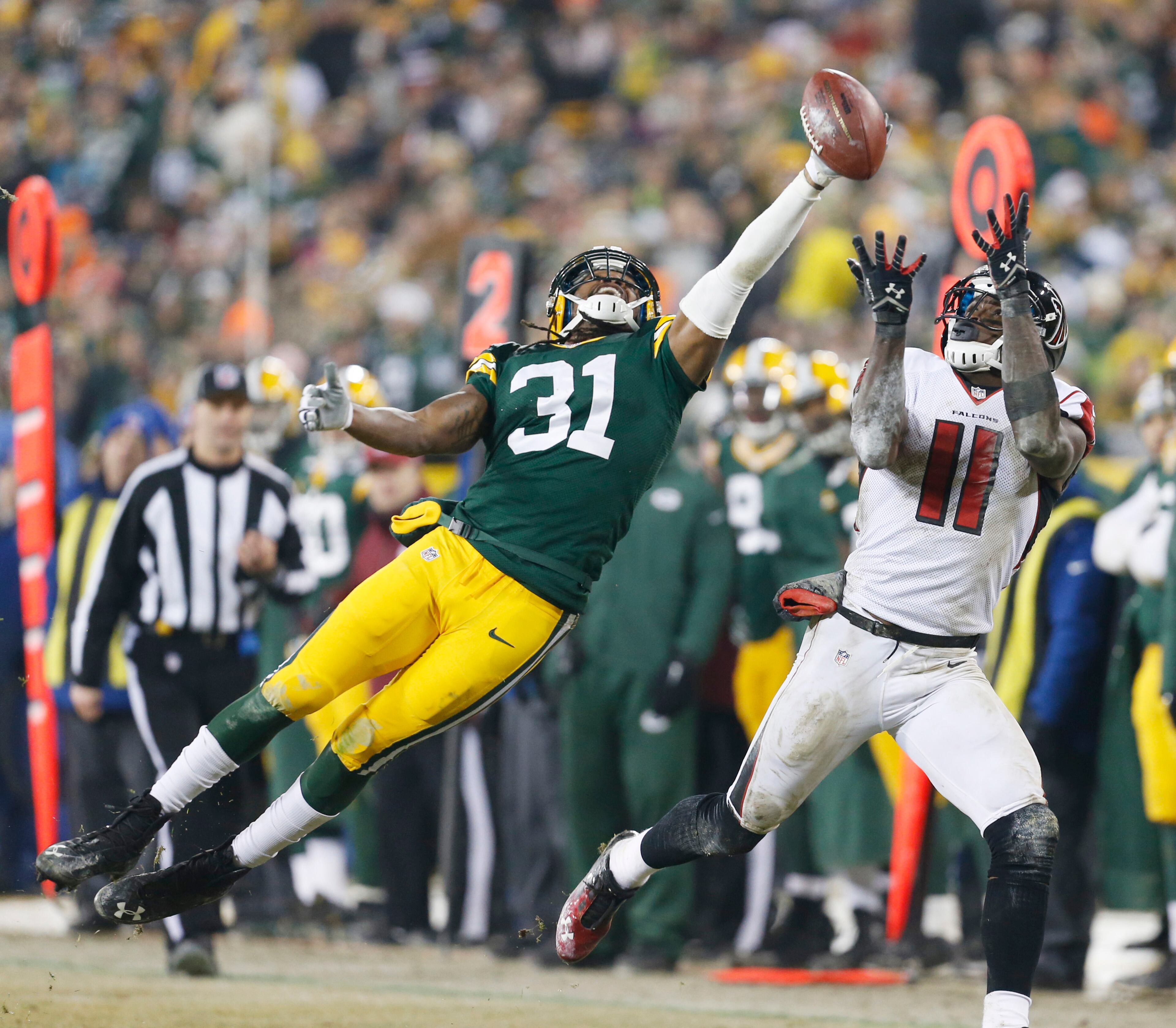 Green Bay Packers' Davon House breaks up a pass intended for Atlanta Falcons' Julio Jones near the end zone during the second half Monday, Dec. 8, 2014, in Green Bay, Wis.