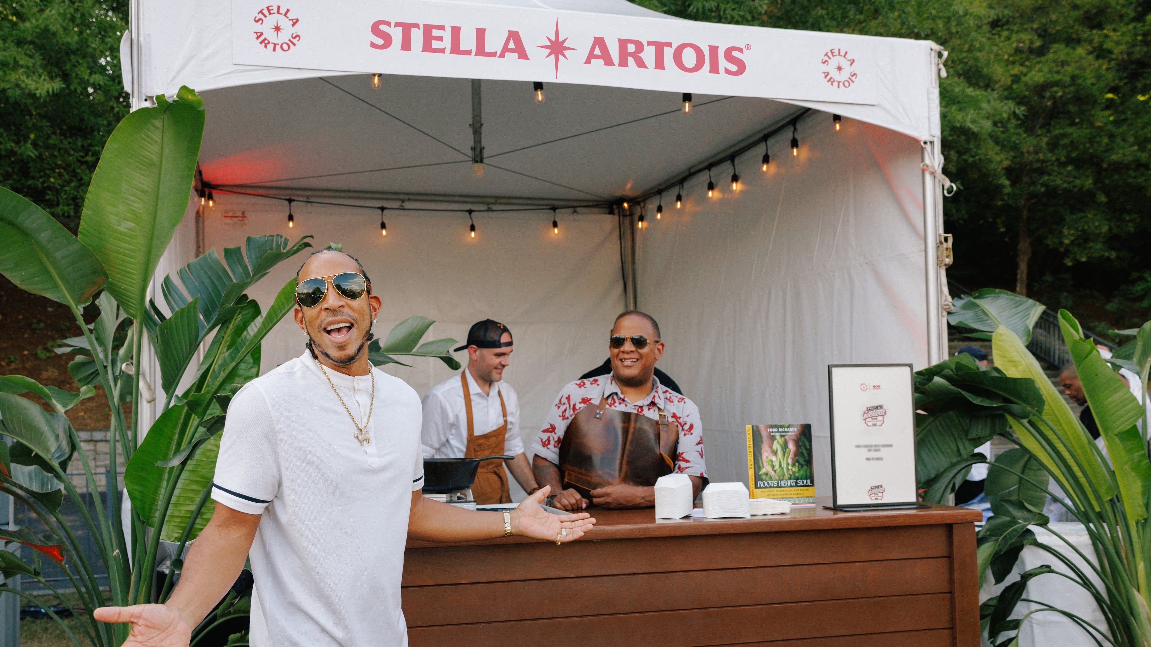 Christopher "Ludacris" Bridges poses in front of his Chicken and Beer restaurant stand at the Luda's Cookout event on August 14, 2024, in Atlanta's Piedmont Park.